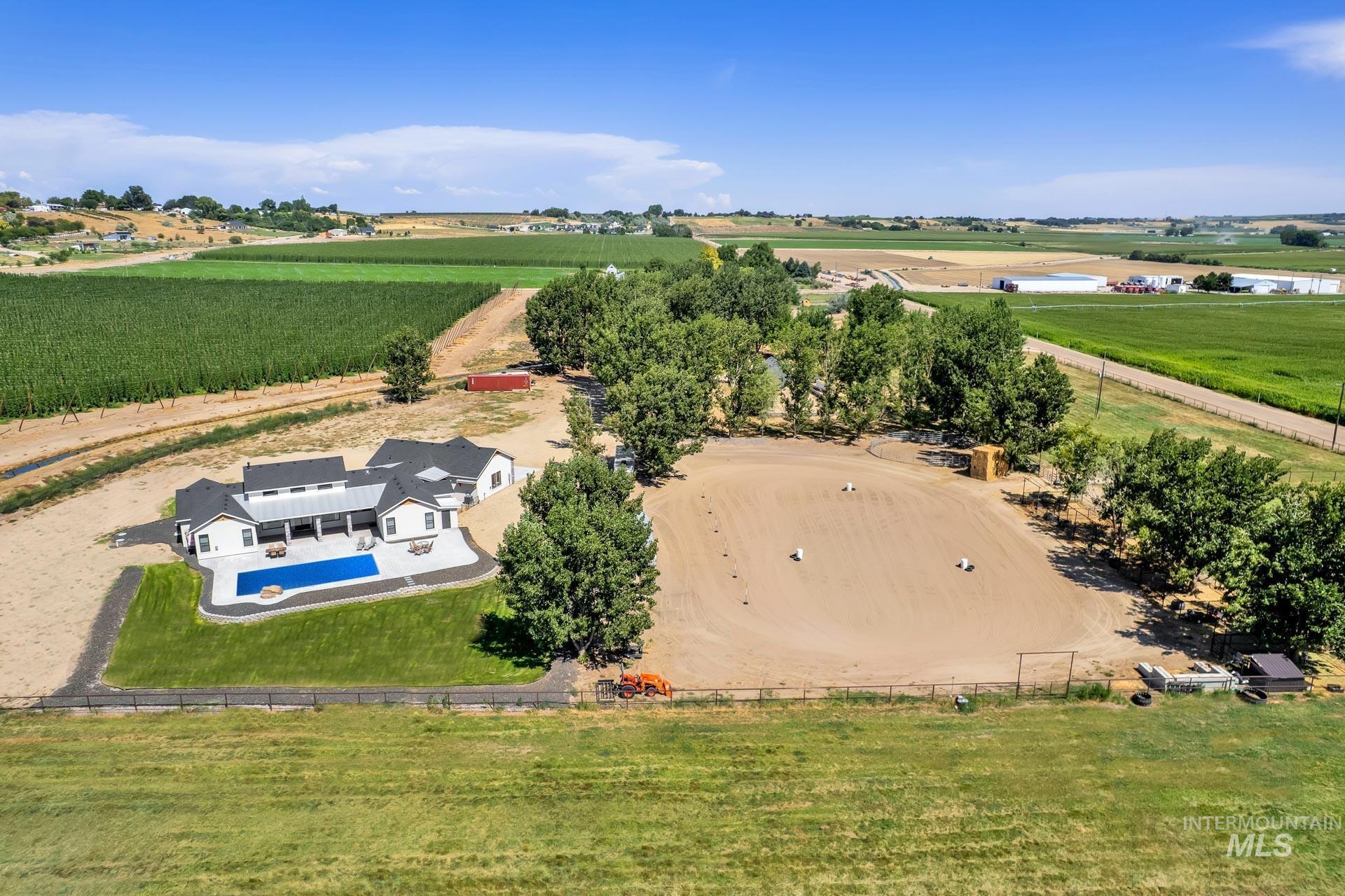 View of rural area featuring a pool area and rows of crops
