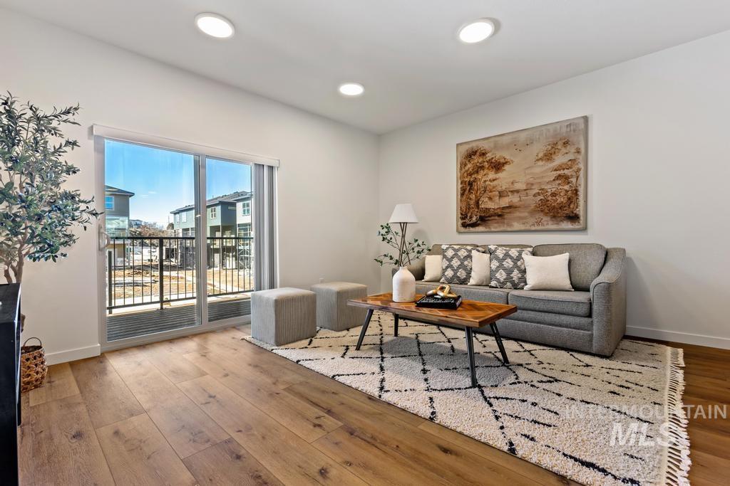Living area featuring wood finished floors and recessed lighting
