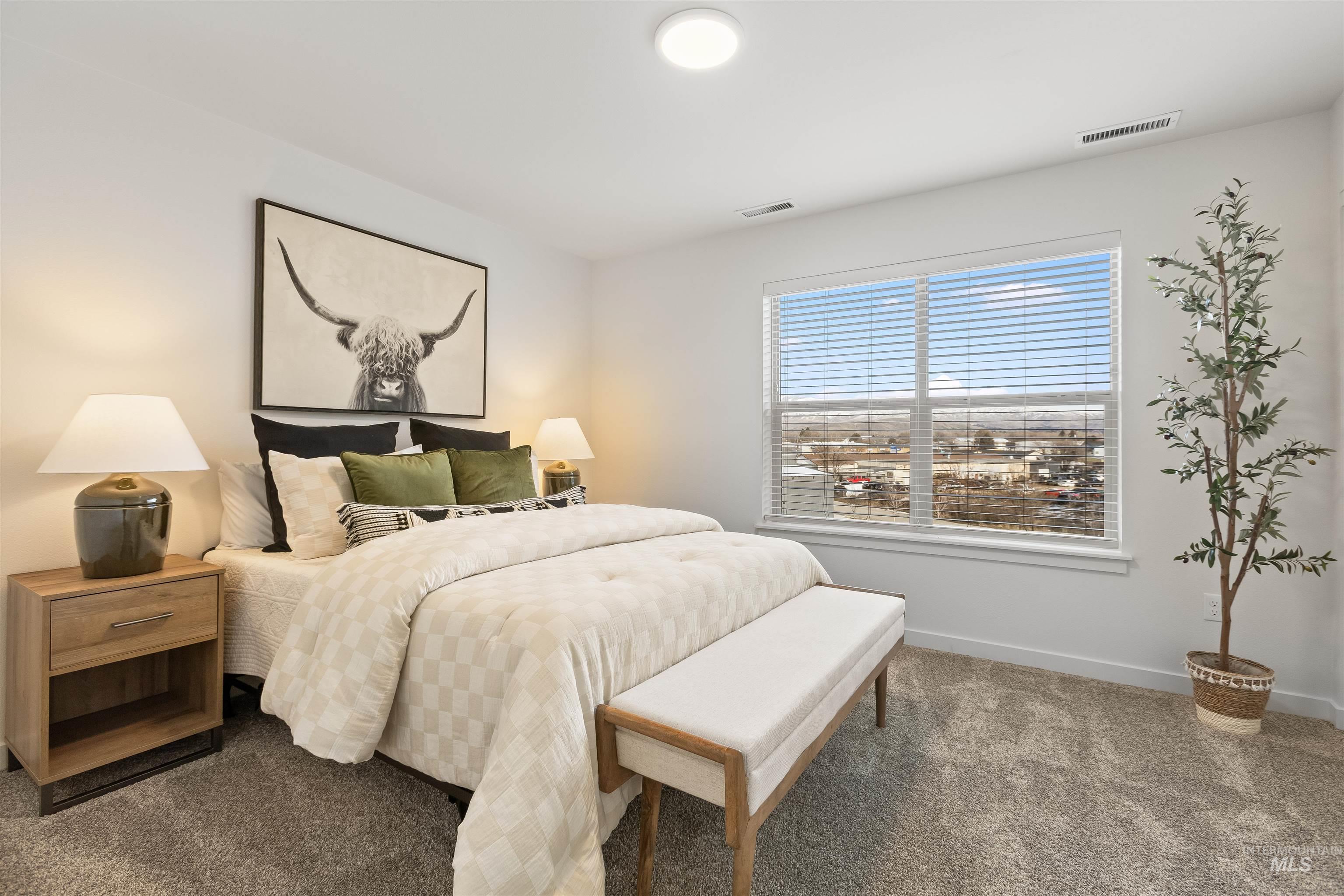 Carpeted bedroom featuring baseboards