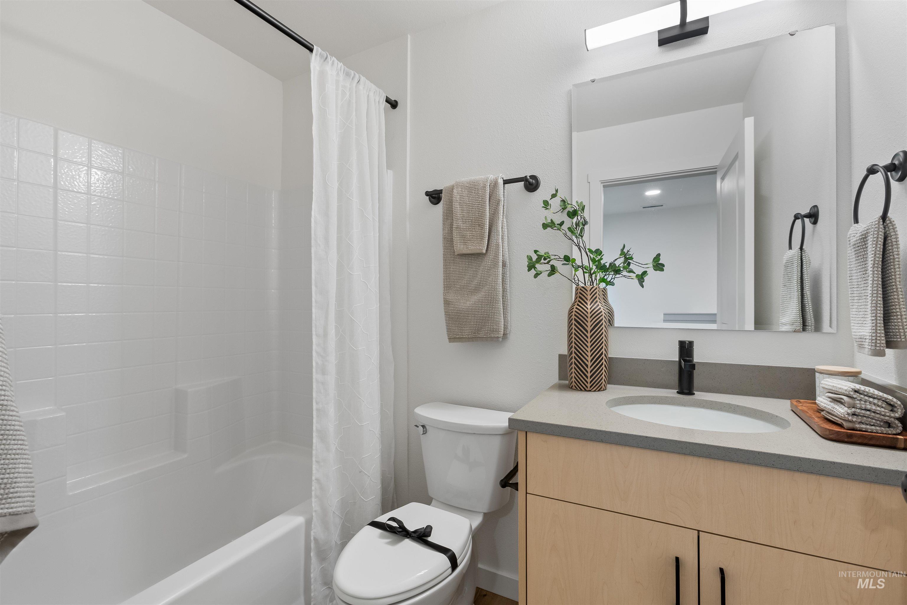 Bathroom featuring vanity and shower / bath combo
