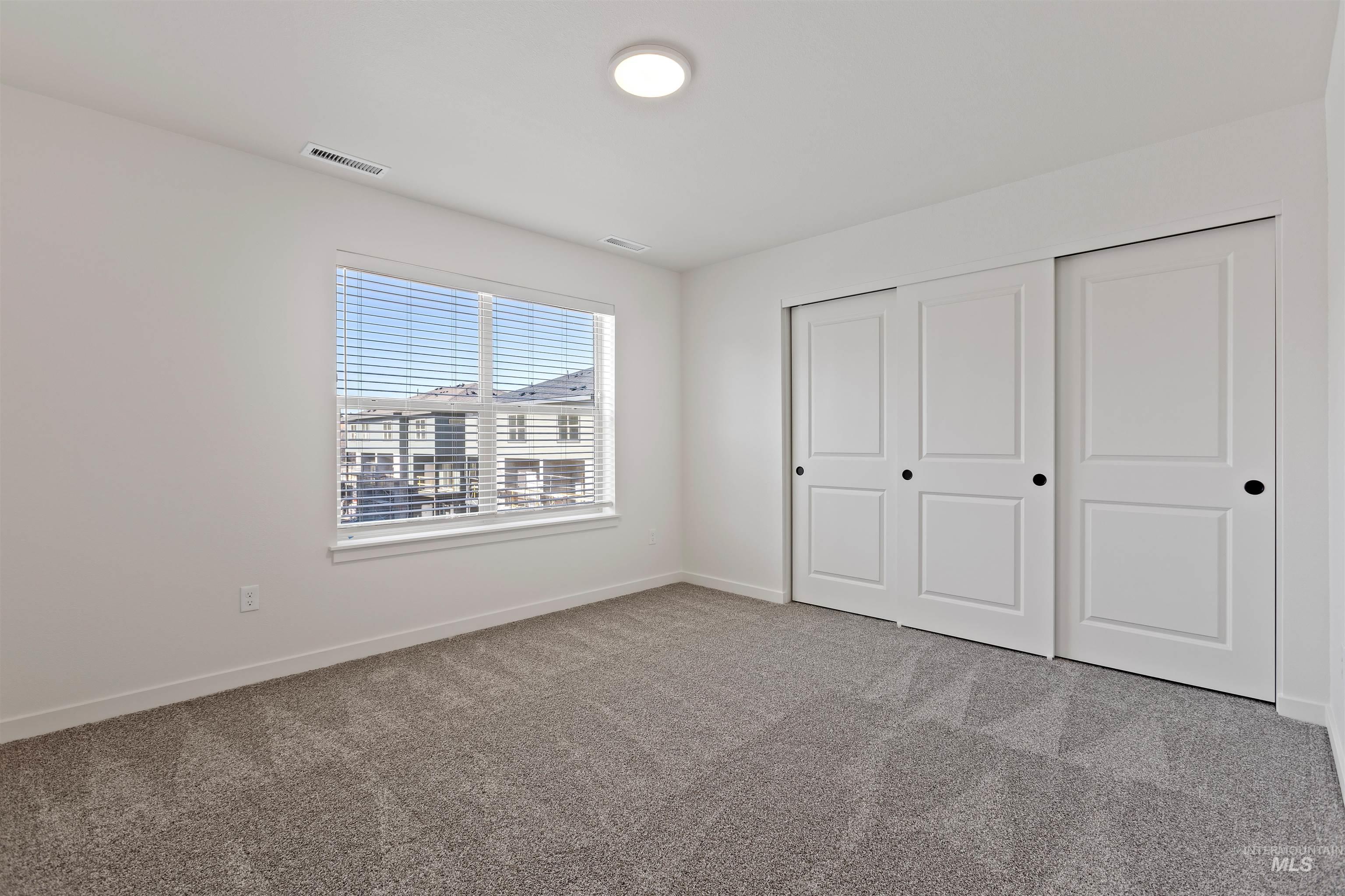 Unfurnished bedroom with carpet and a closet
