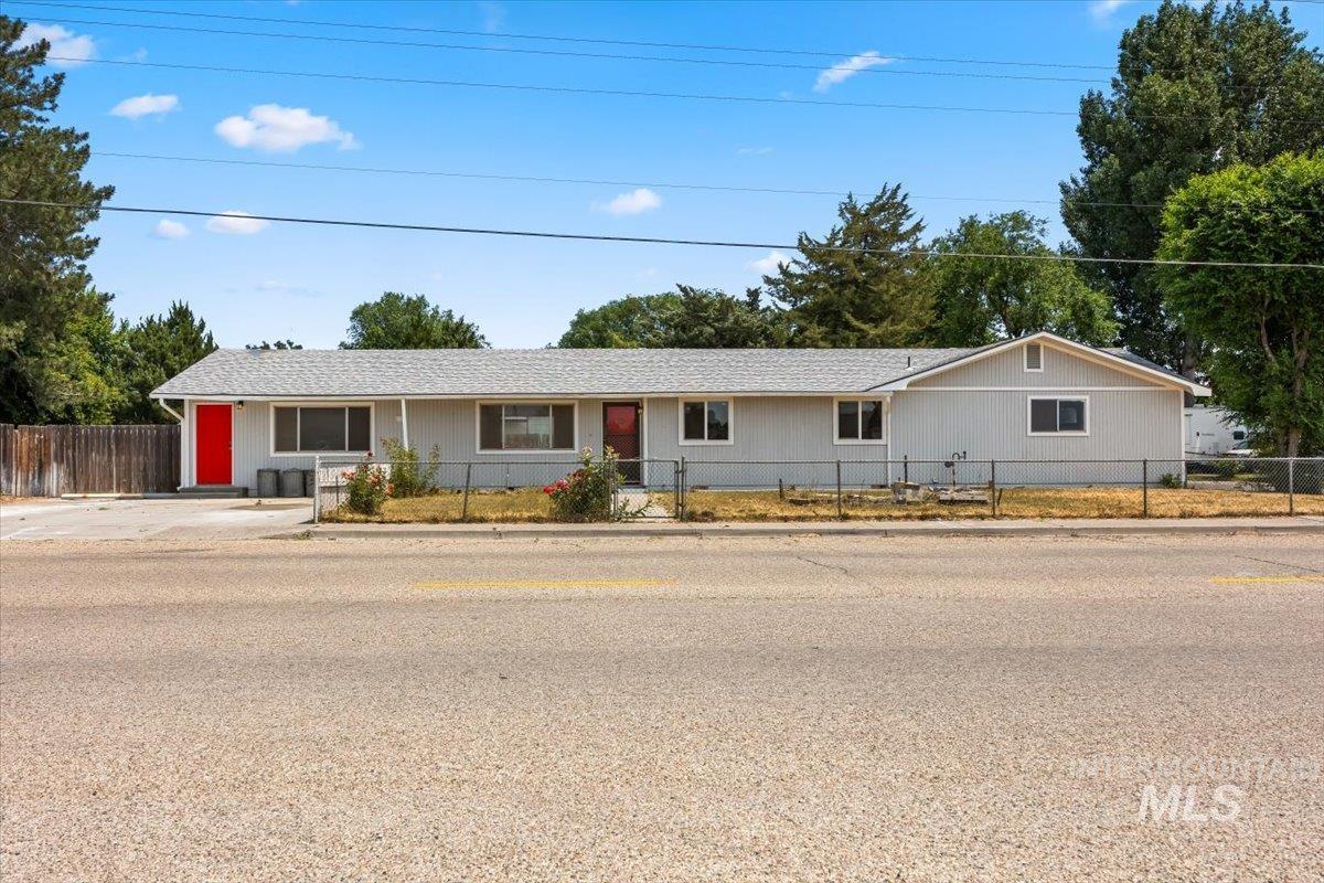 Single story home featuring a fenced front yard