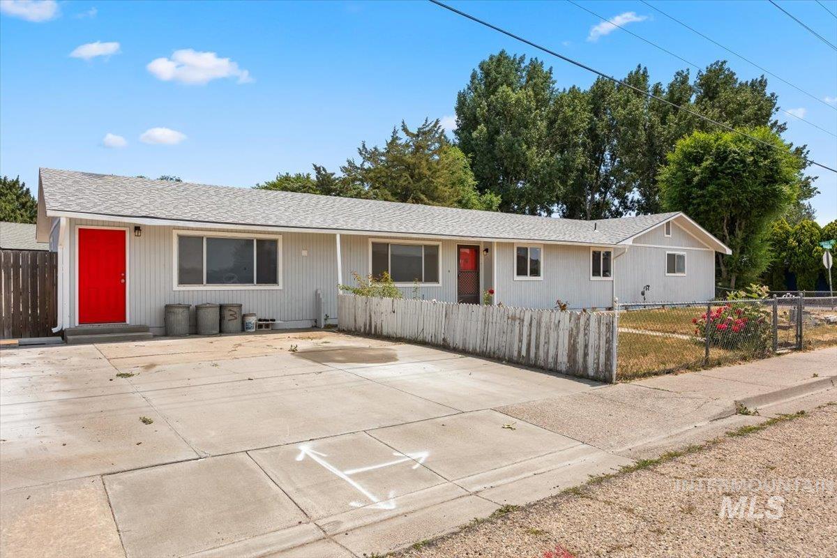 Single story home with roof with shingles and a fenced front yard