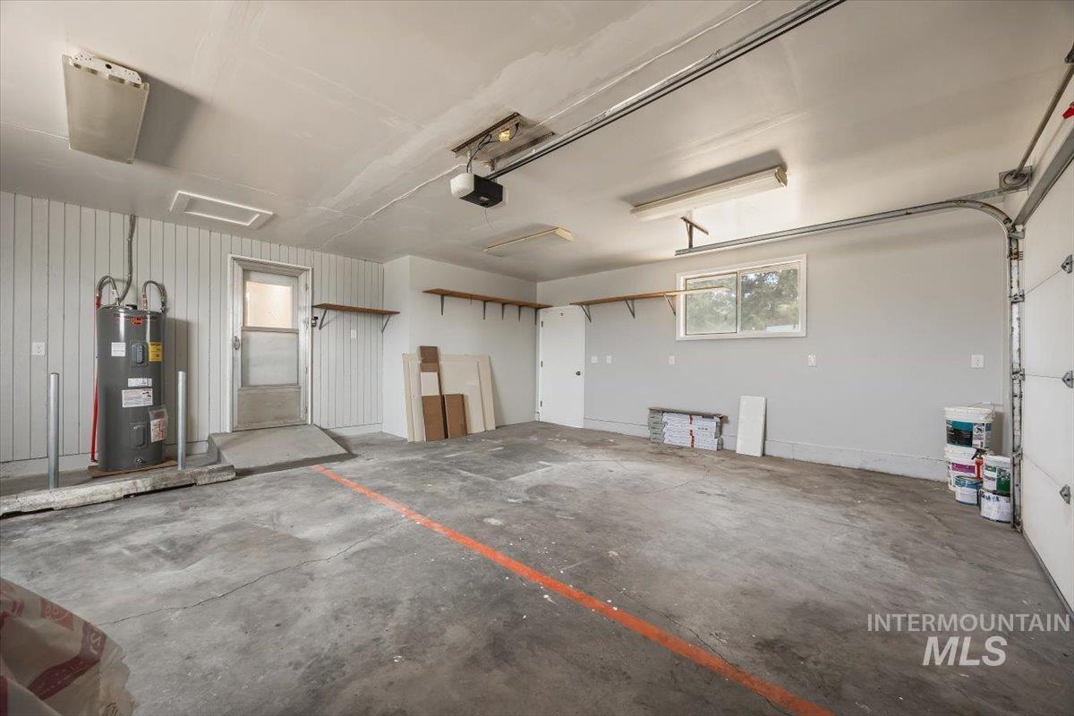 Garage with water heater and a garage door opener