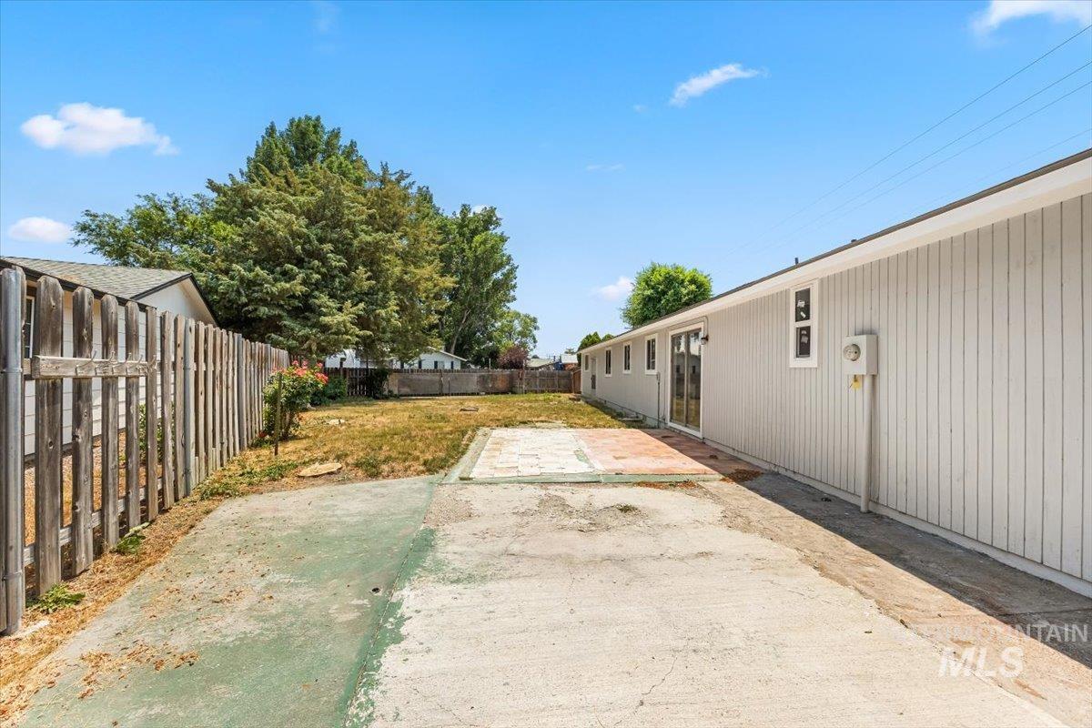 Fenced backyard with a patio area