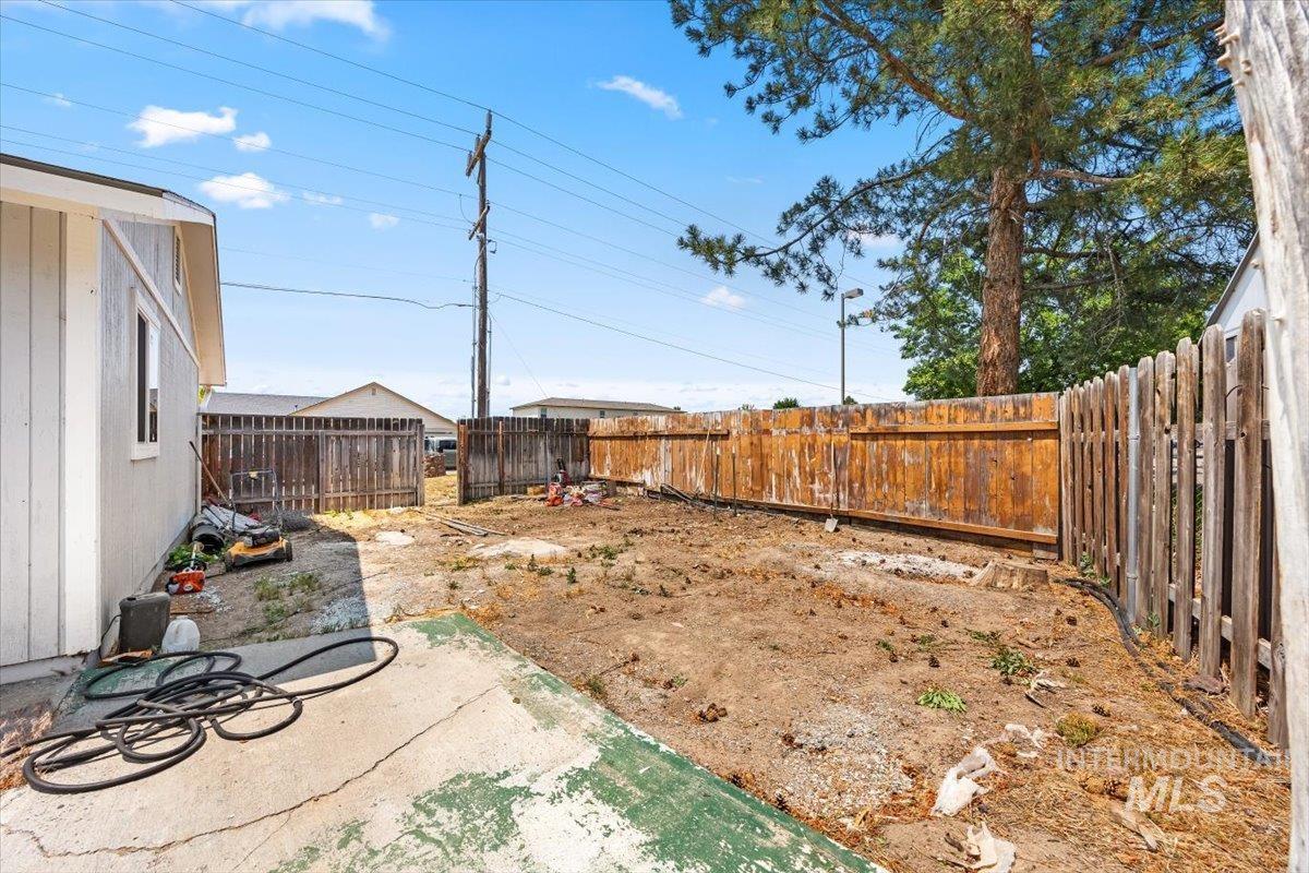 Fenced backyard with a patio area