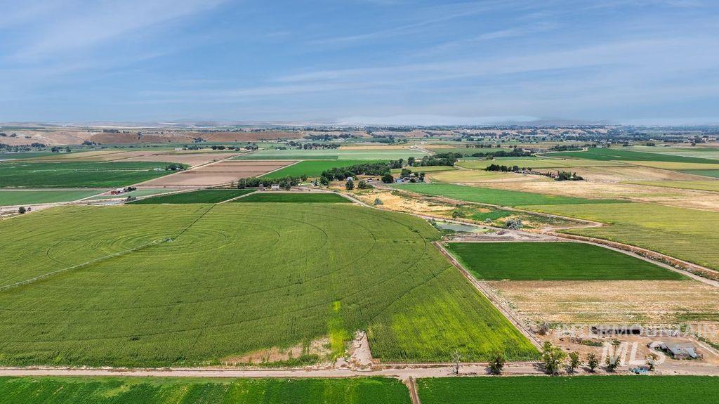 Aerial view of sparsely populated area with large plots for crops