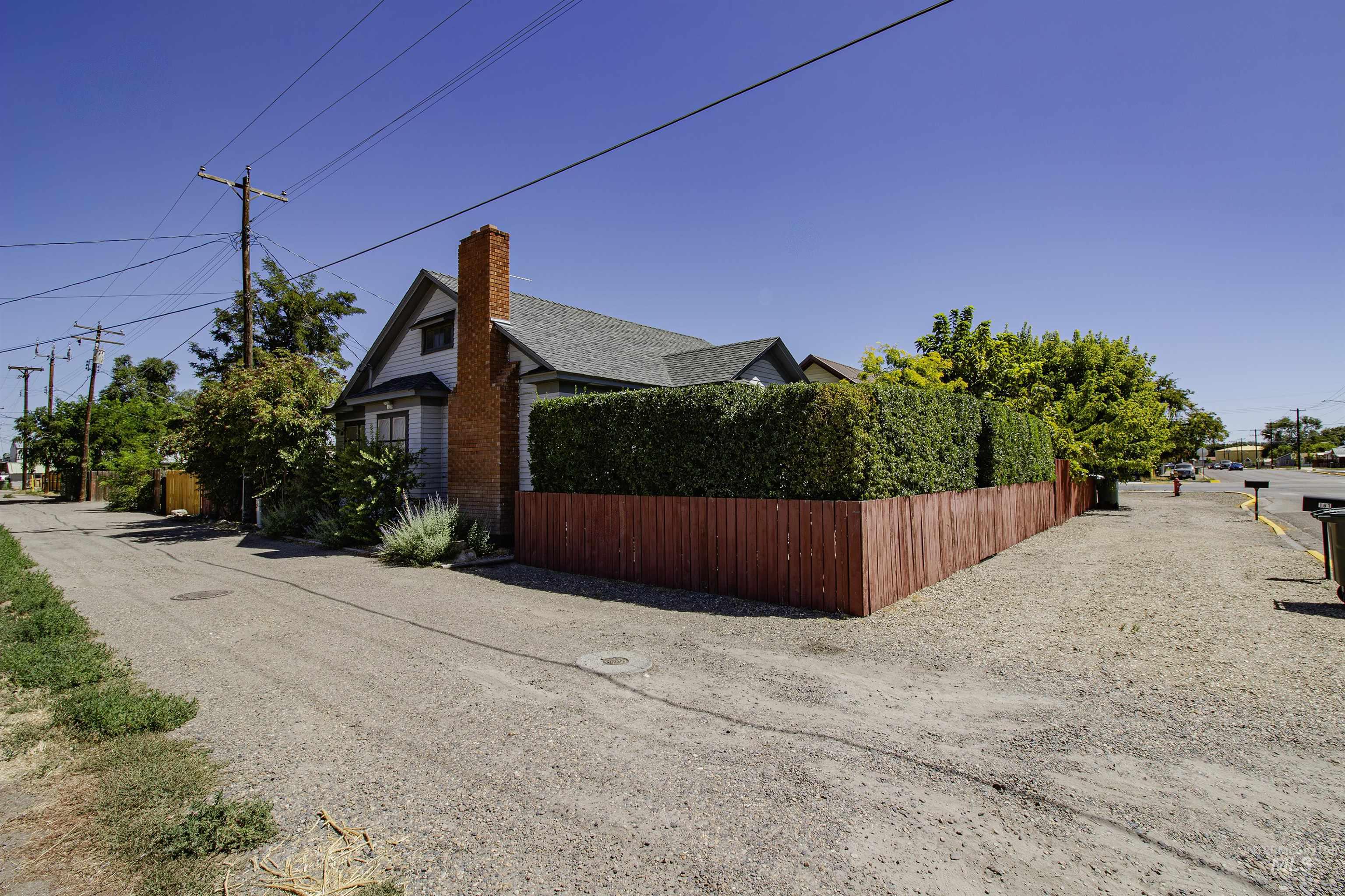 Fenced backyard is accessible from the alley