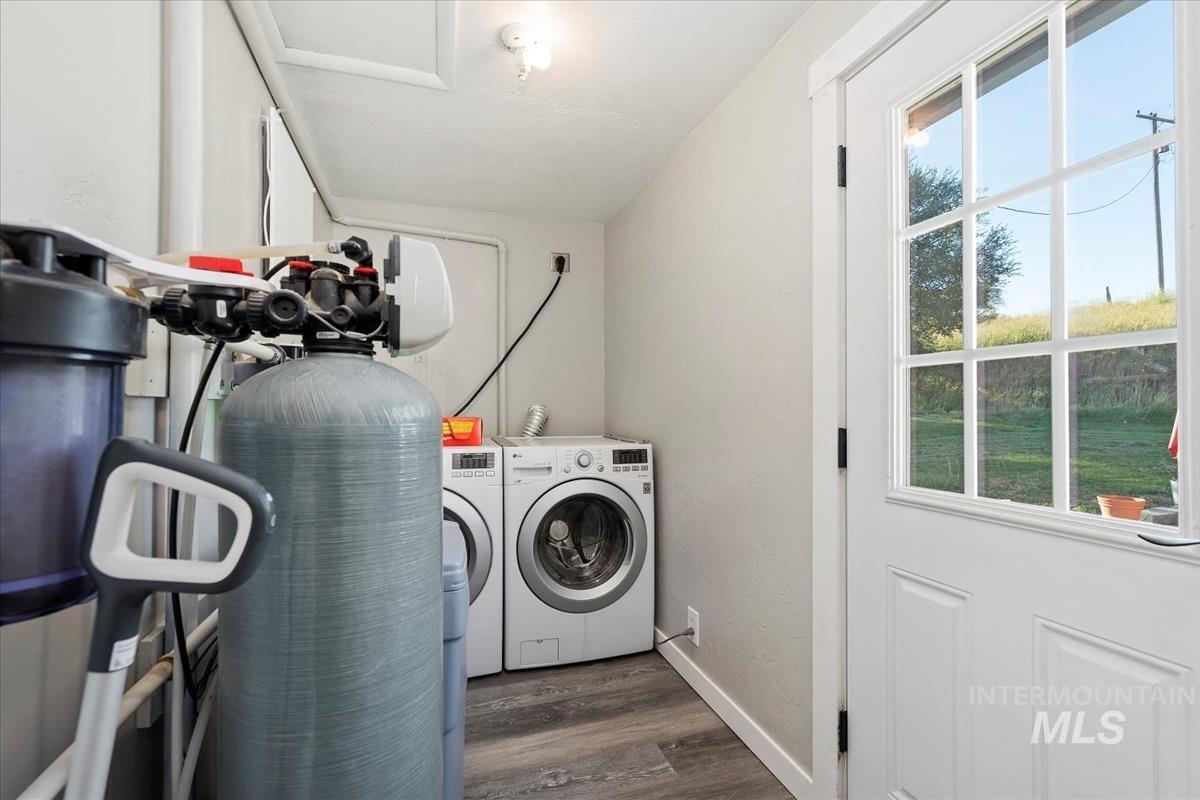Laundry room with washer and dryer and dark wood finished floors