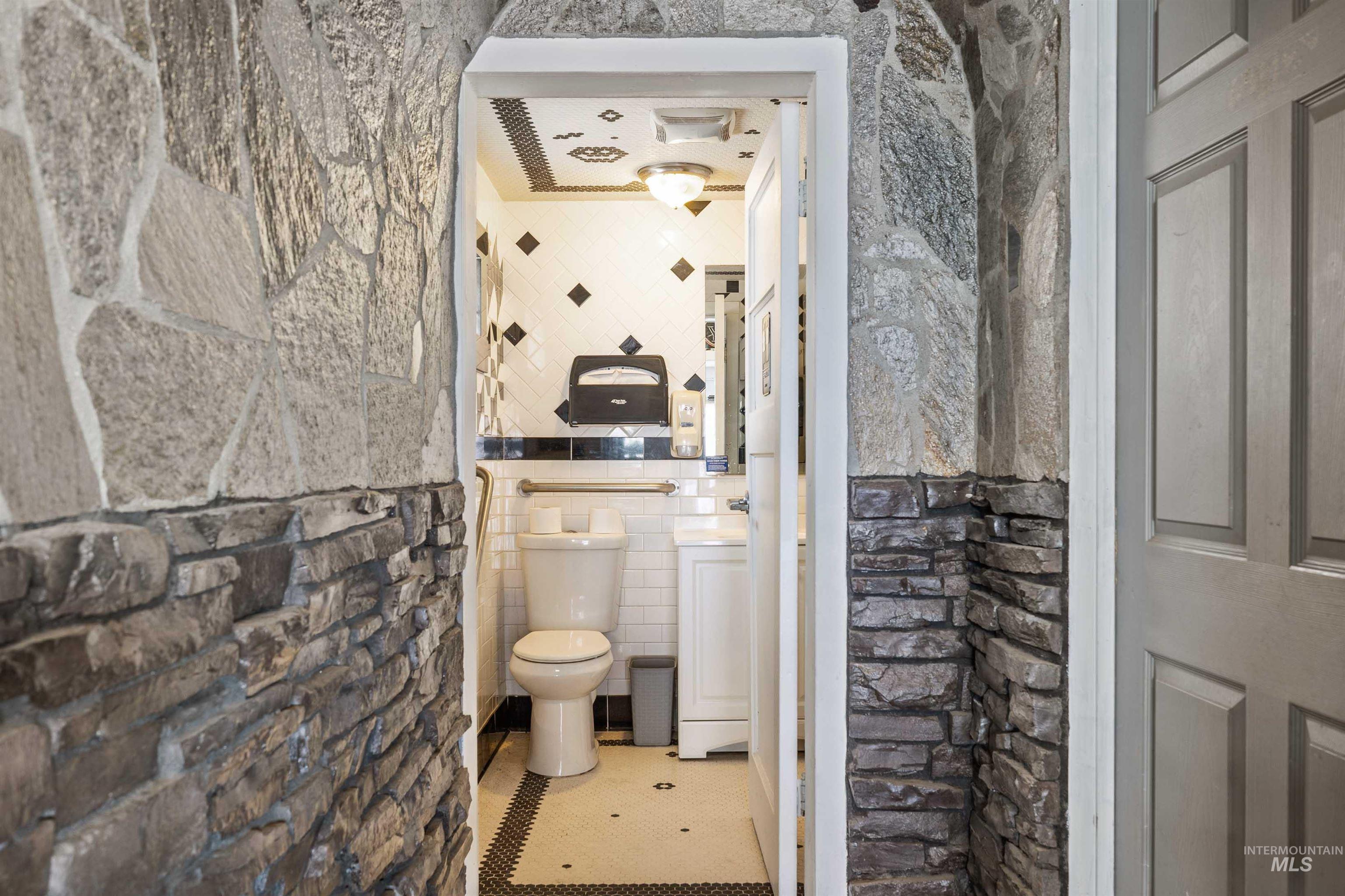 Bathroom featuring tile walls and tile patterned floors