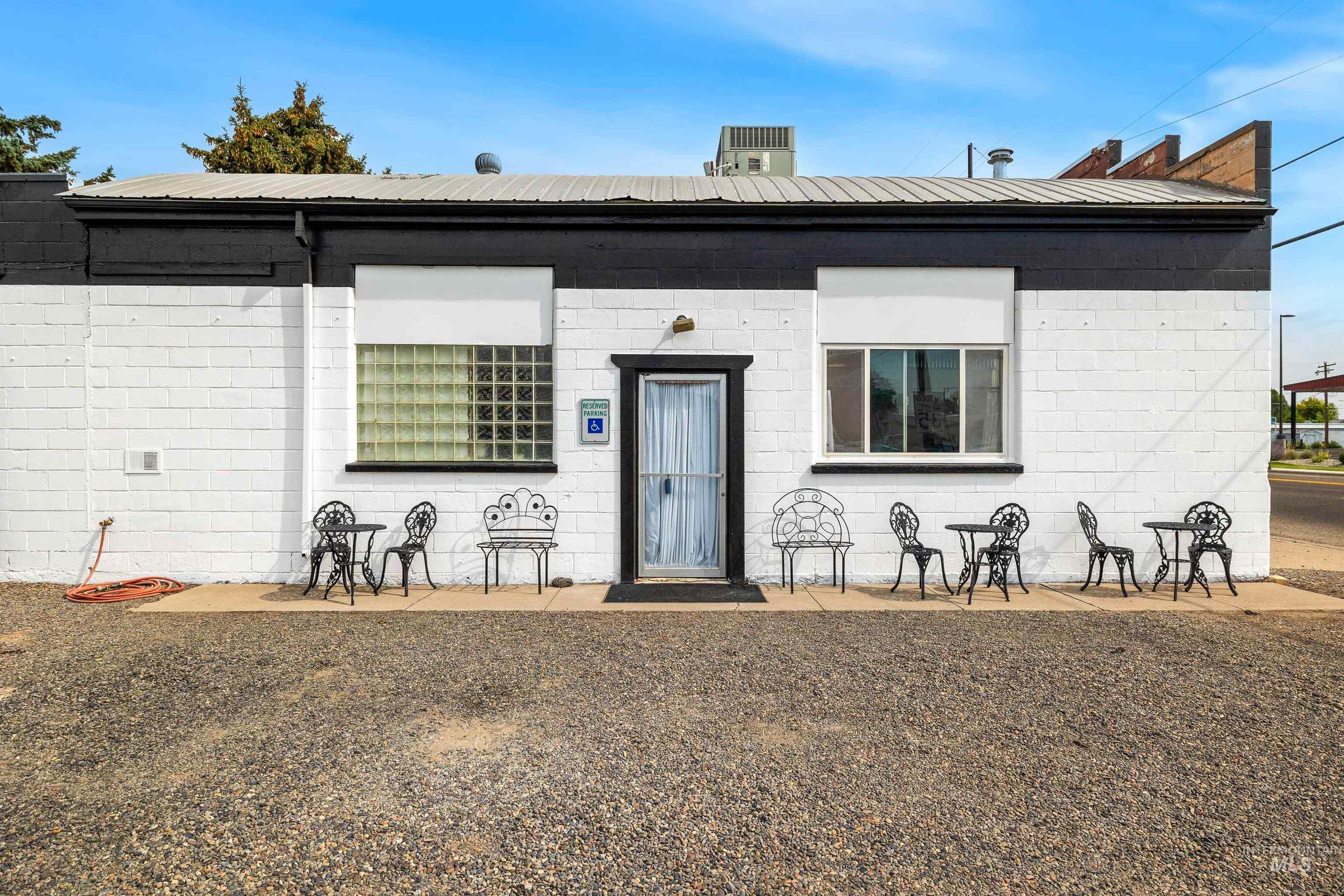 View of front of home featuring concrete block siding and a patio