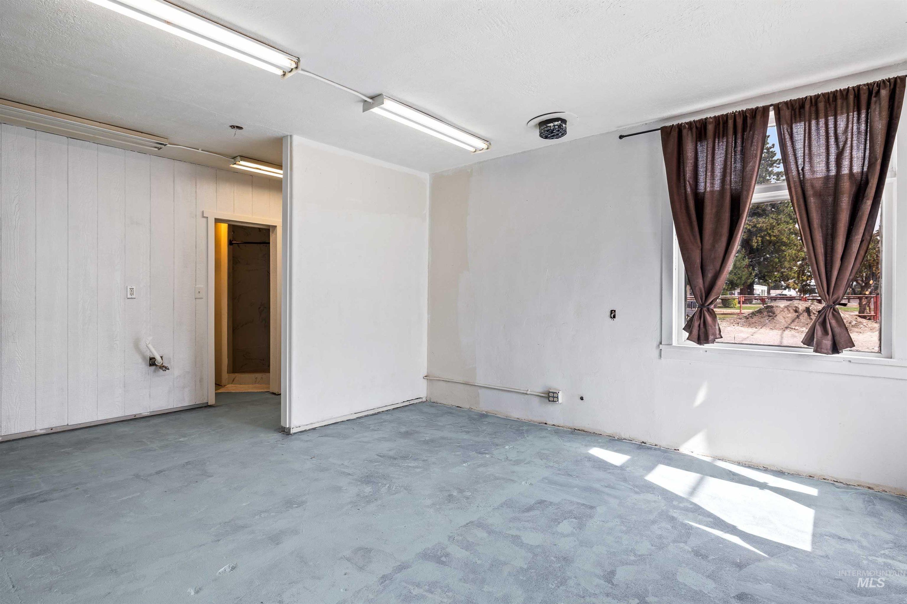 Spare room featuring concrete floors and wooden walls