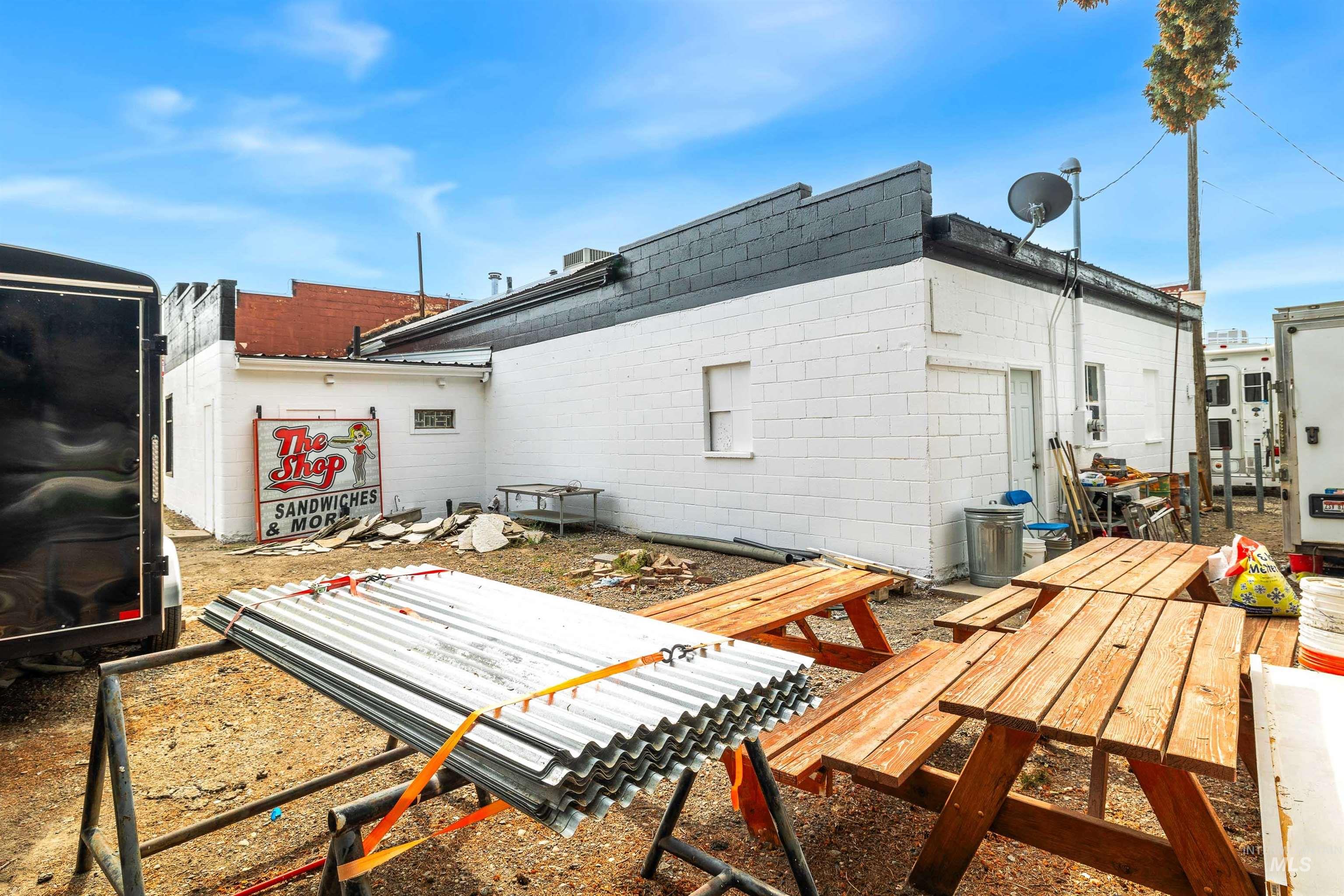Rear view of property with concrete block siding