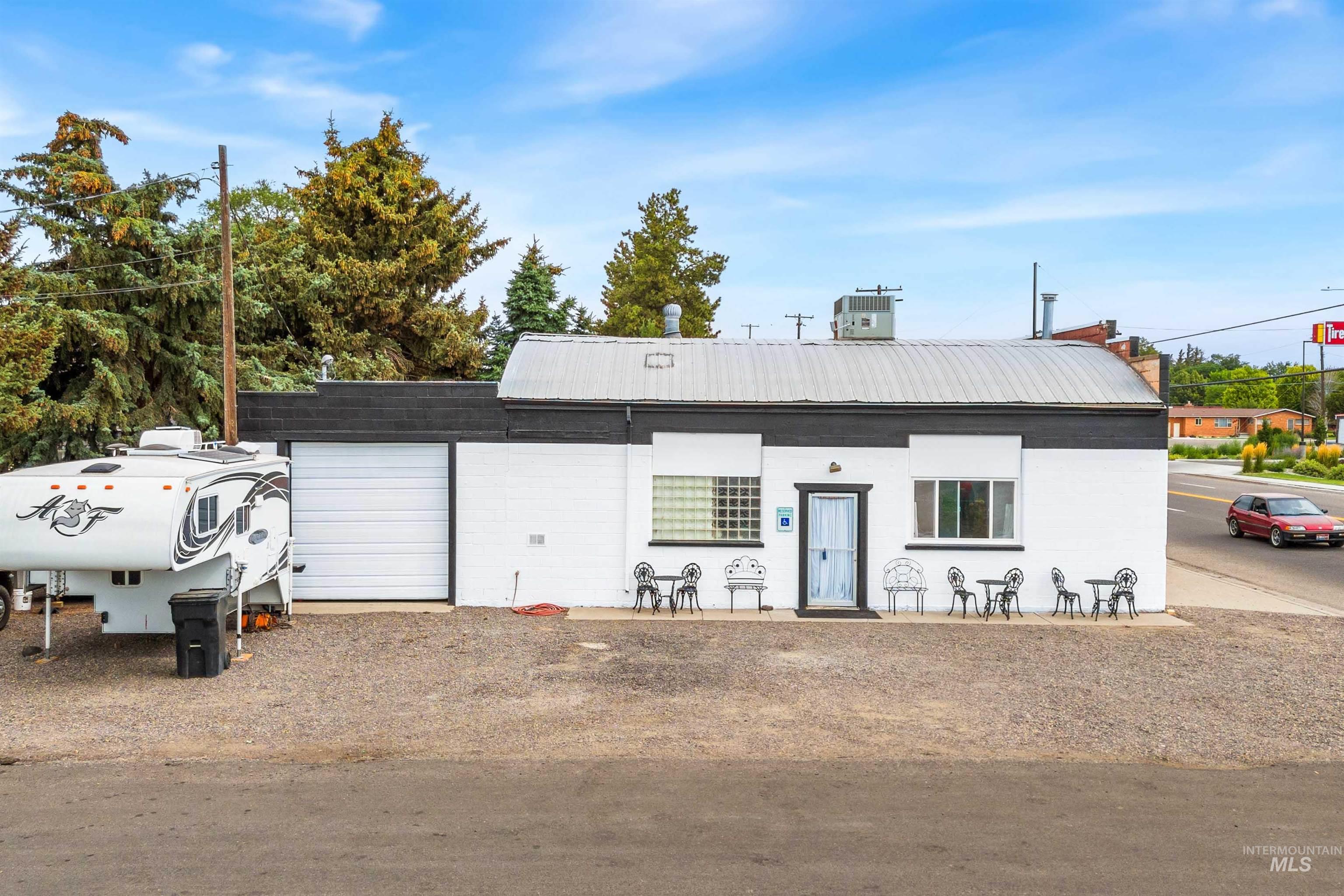 View of front of property with a metal roof and a patio area