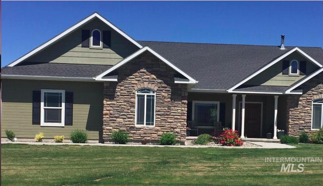 Craftsman house with stone siding and a front lawn