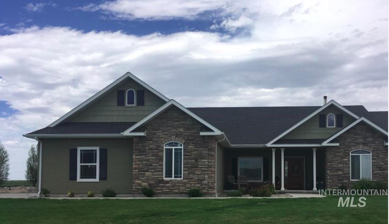 Craftsman-style home with stone siding and a front lawn