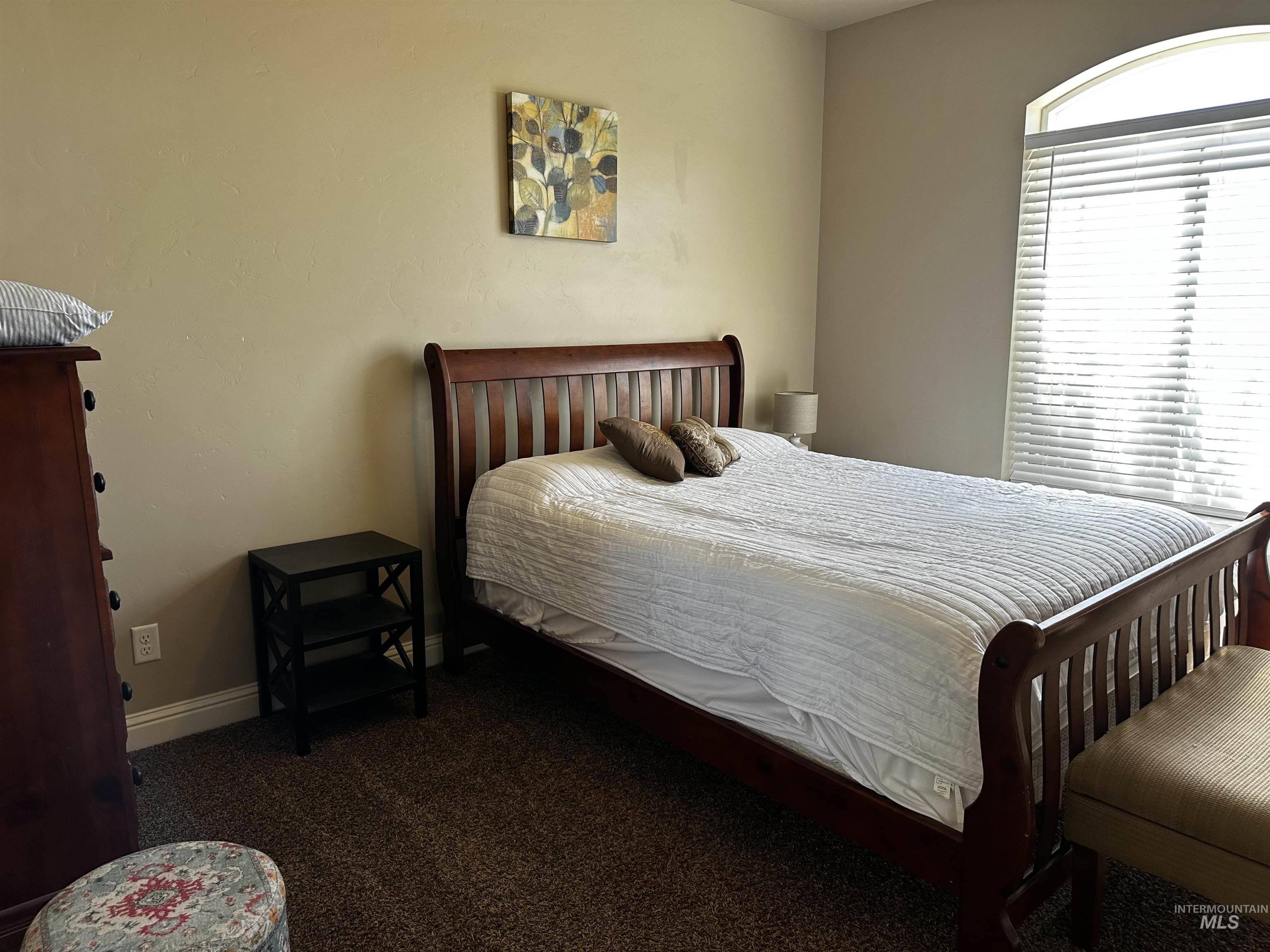 Carpeted bedroom featuring baseboards