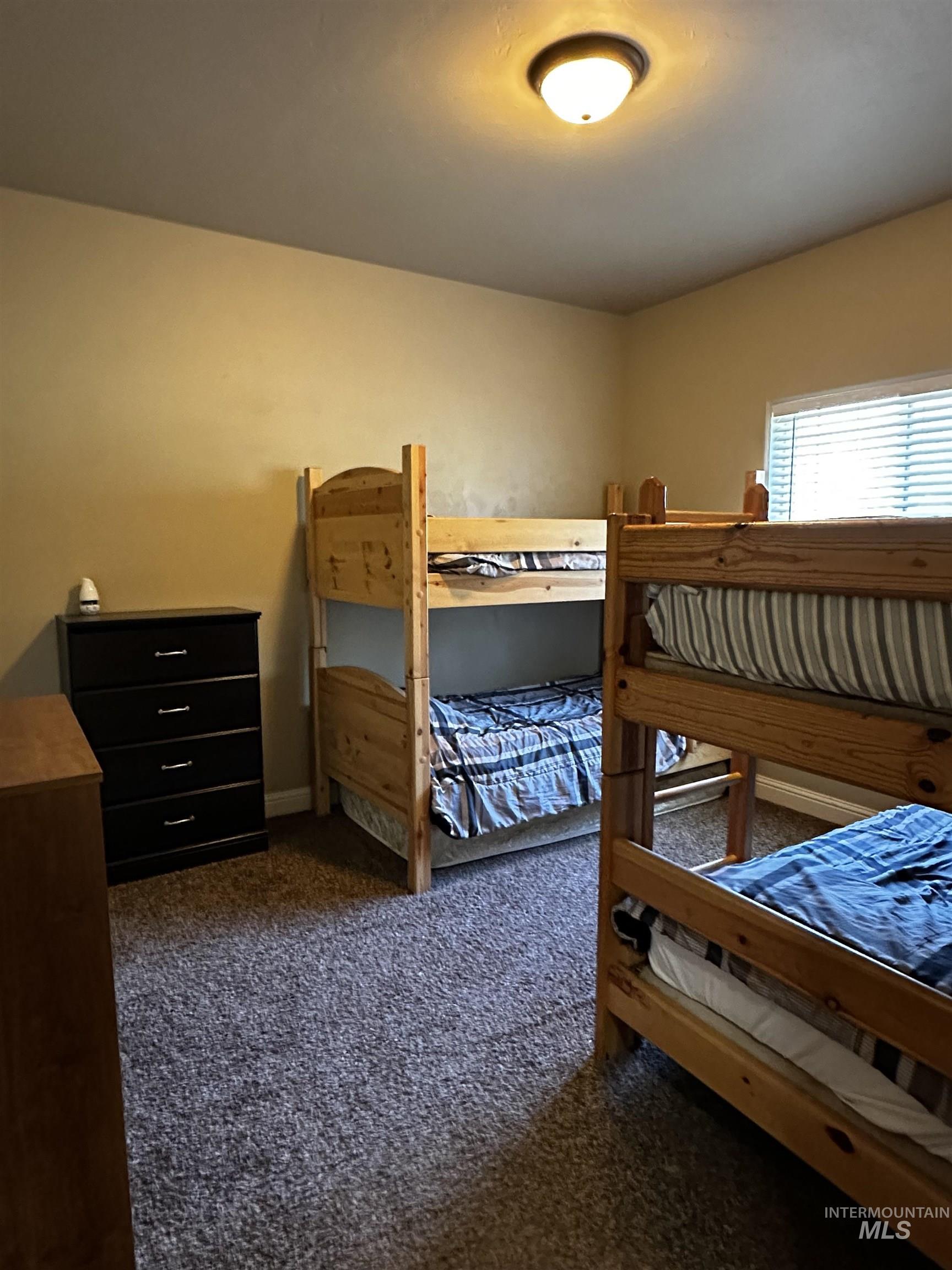 Bedroom with dark colored carpet
