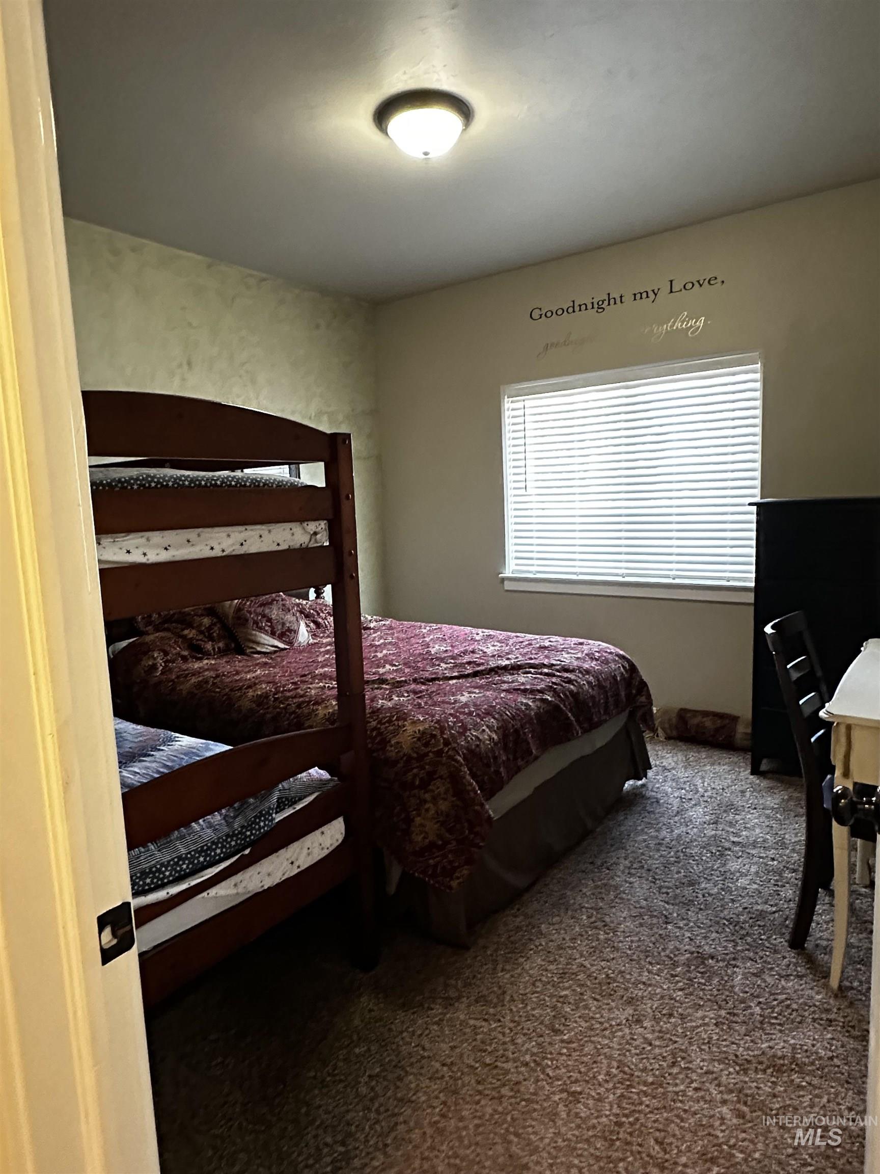 Bedroom featuring dark carpet