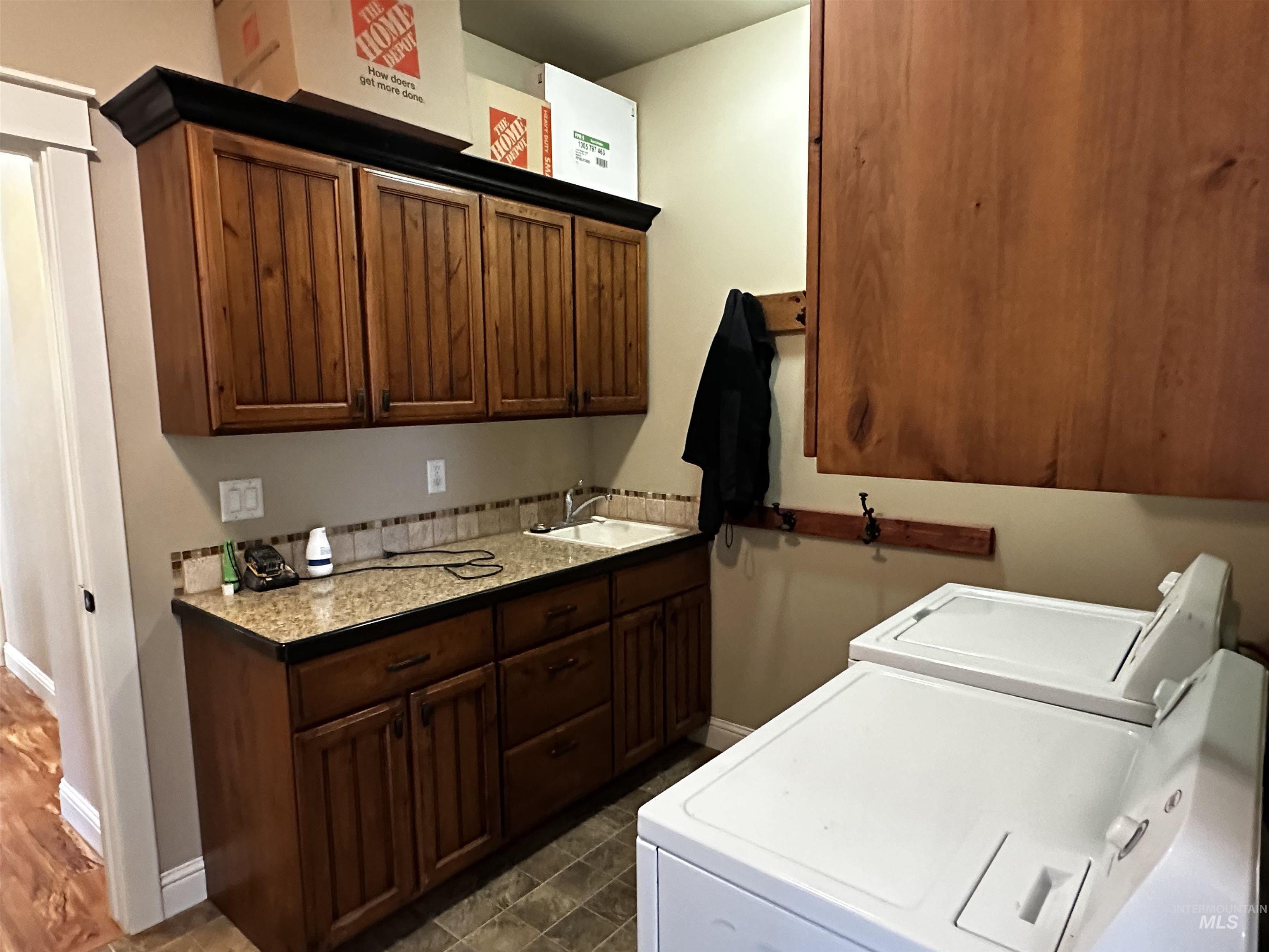 Washroom featuring cabinet space and separate washer and dryer