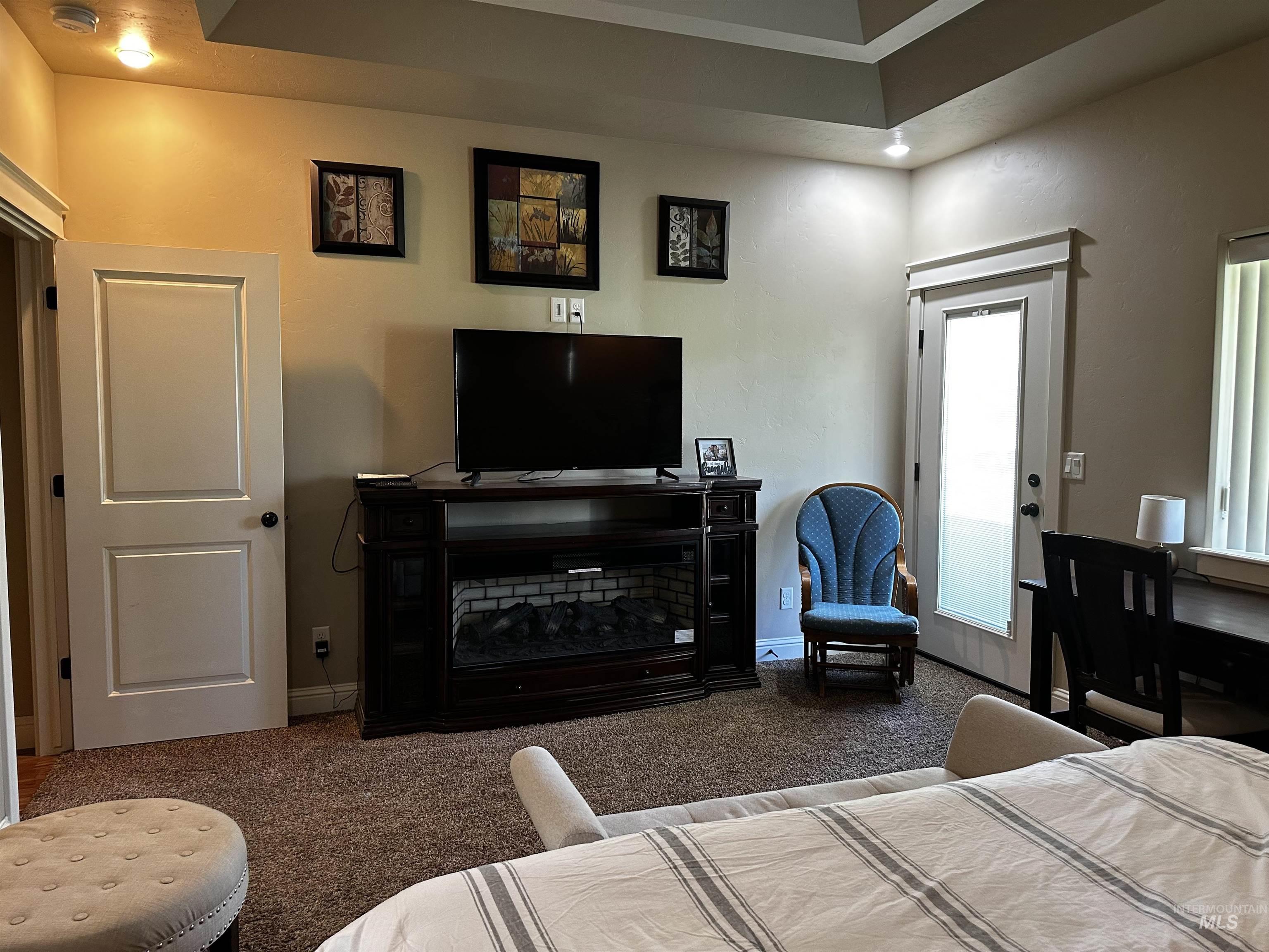Living area with carpet flooring and baseboards