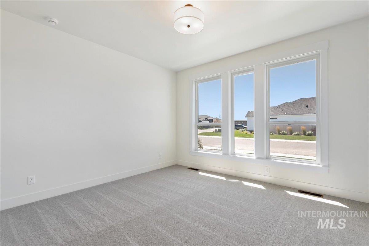 Empty room with carpet floors and baseboards