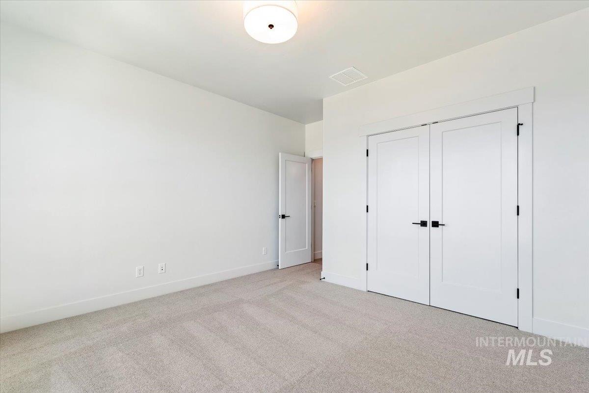 Unfurnished bedroom featuring carpet flooring and a closet
