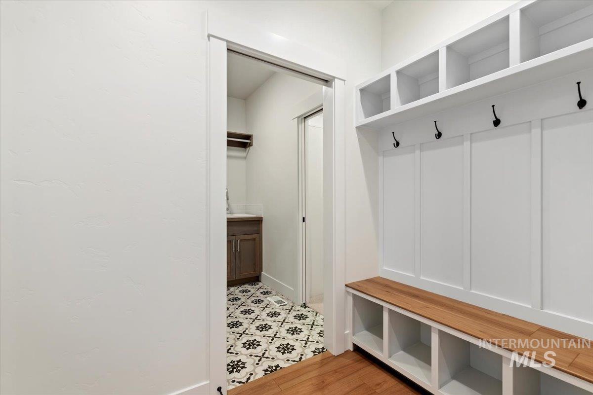 Mudroom featuring light wood-style floors and baseboards