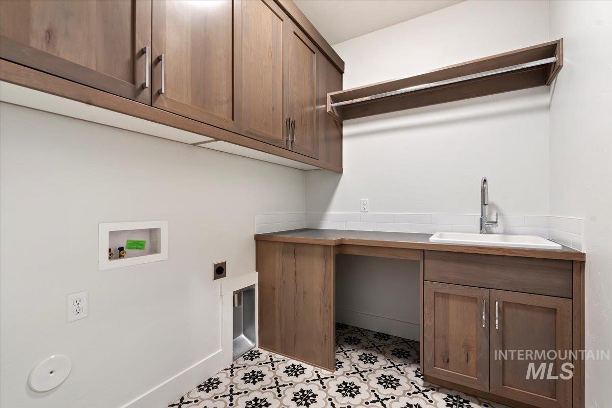Laundry room featuring cabinet space, hookup for a washing machine, and hookup for an electric dryer