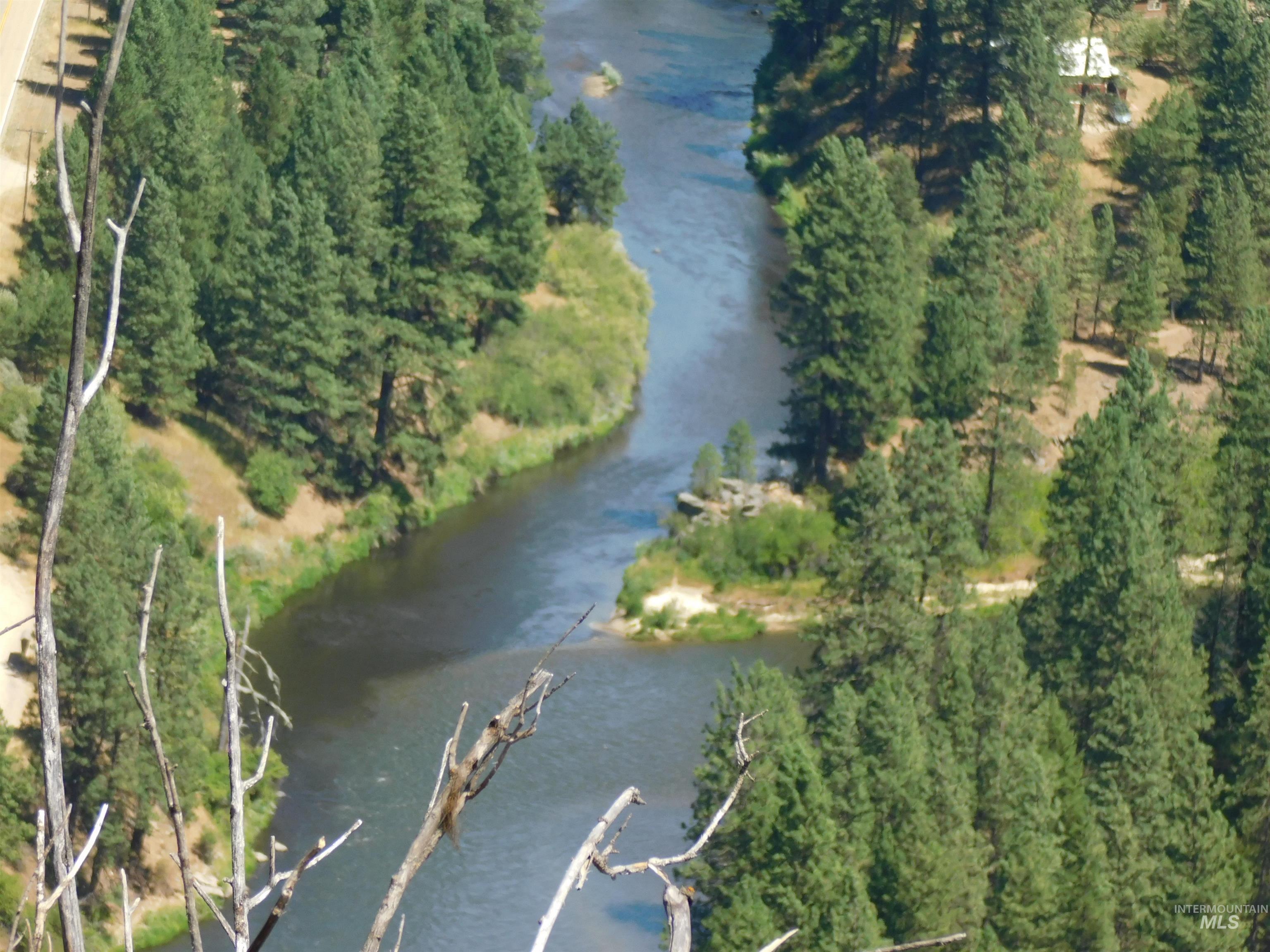 Aerial view of property and surrounding area with a nearby body of water