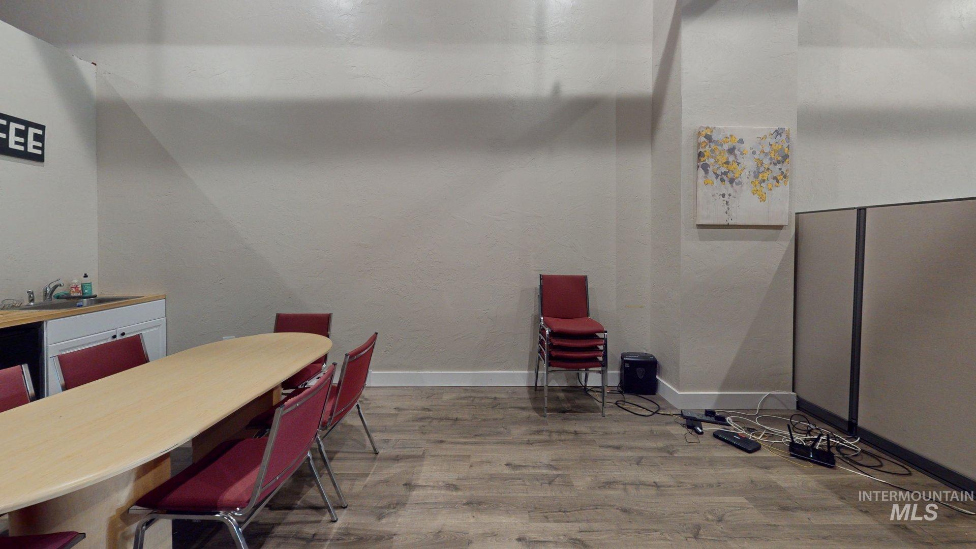 Dining area featuring wood finished floors and a textured wall