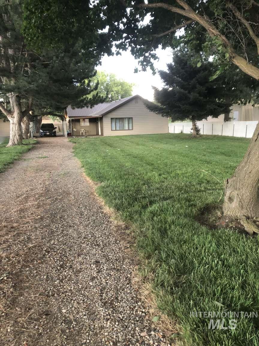 View of front of home featuring dirt driveway