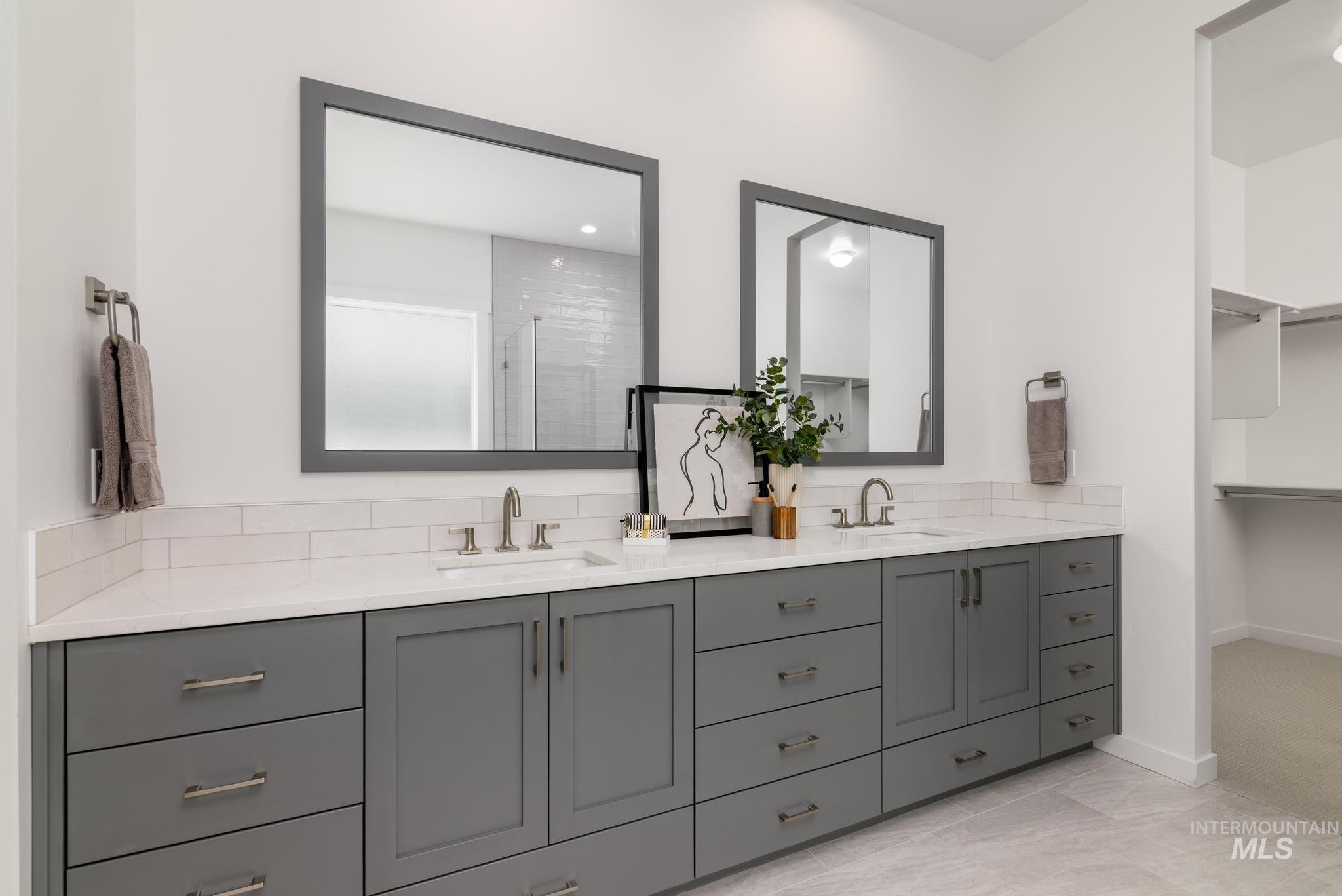 Bathroom with a shower stall, a spacious closet, and recessed lighting