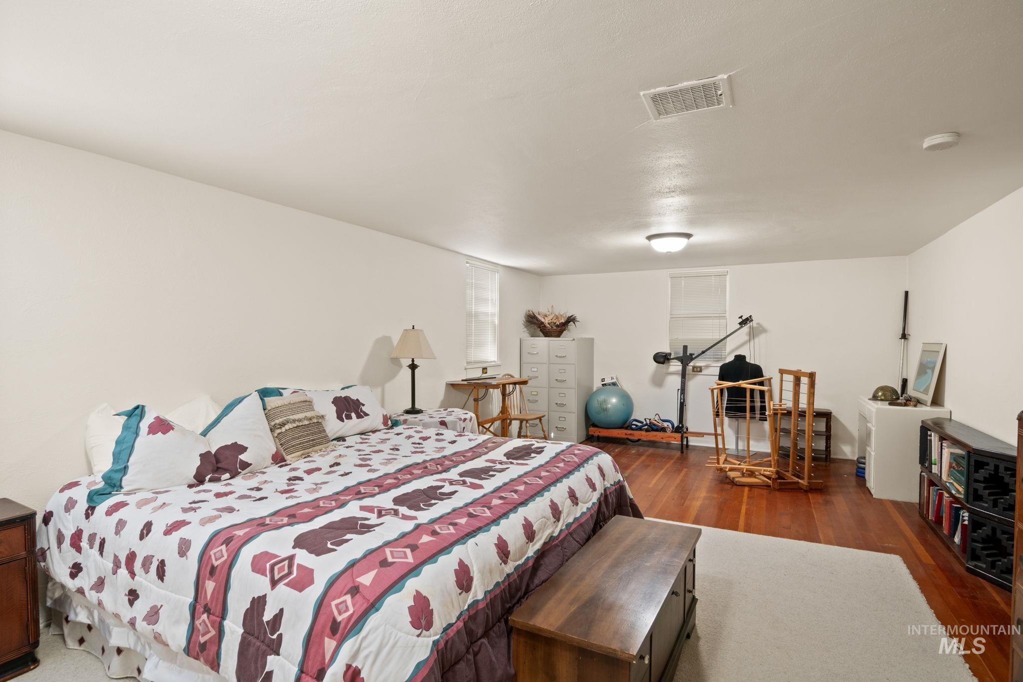 Bedroom with dark wood finished floors