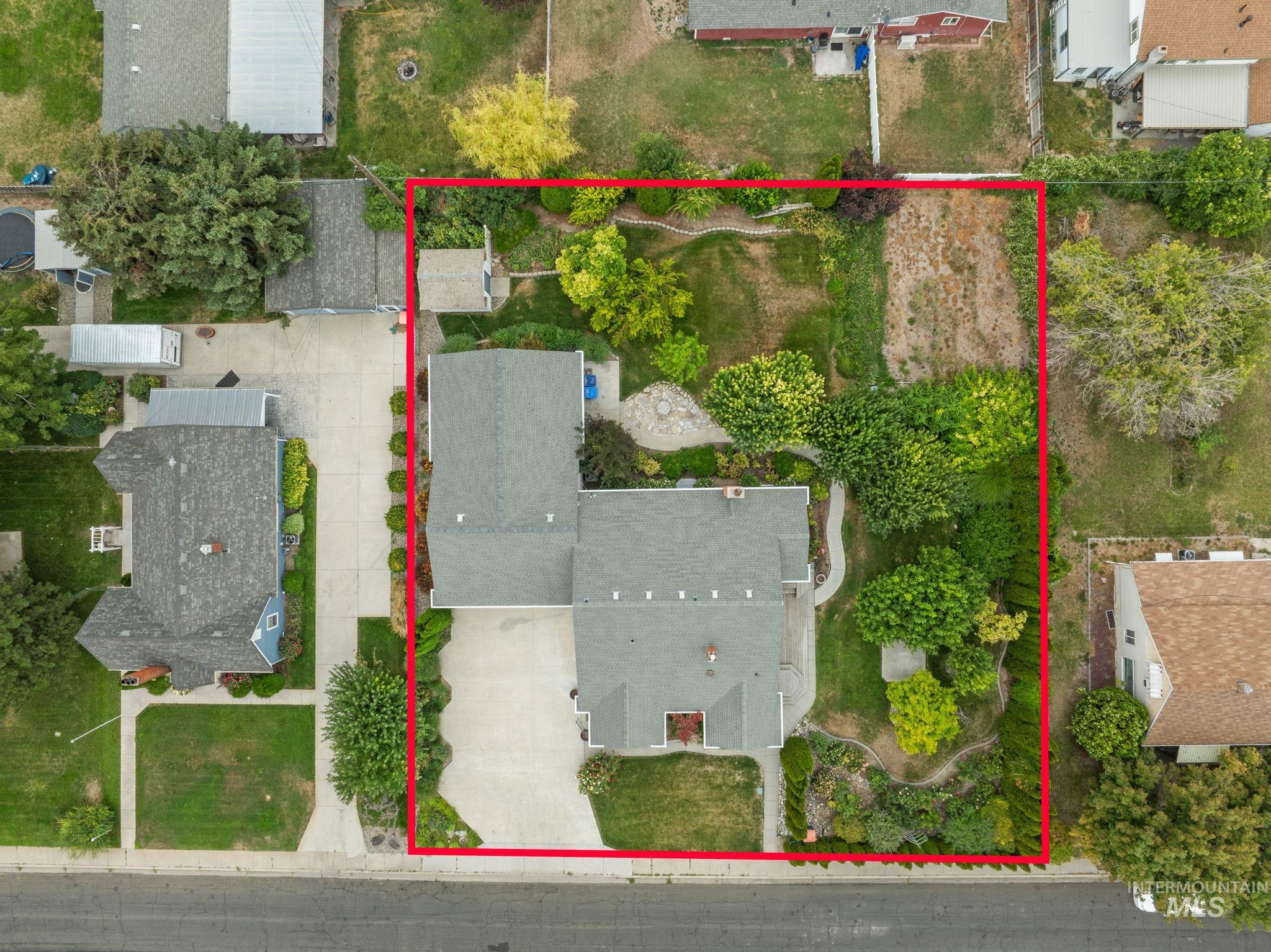 Aerial view of property and surrounding area featuring property parcel outlined