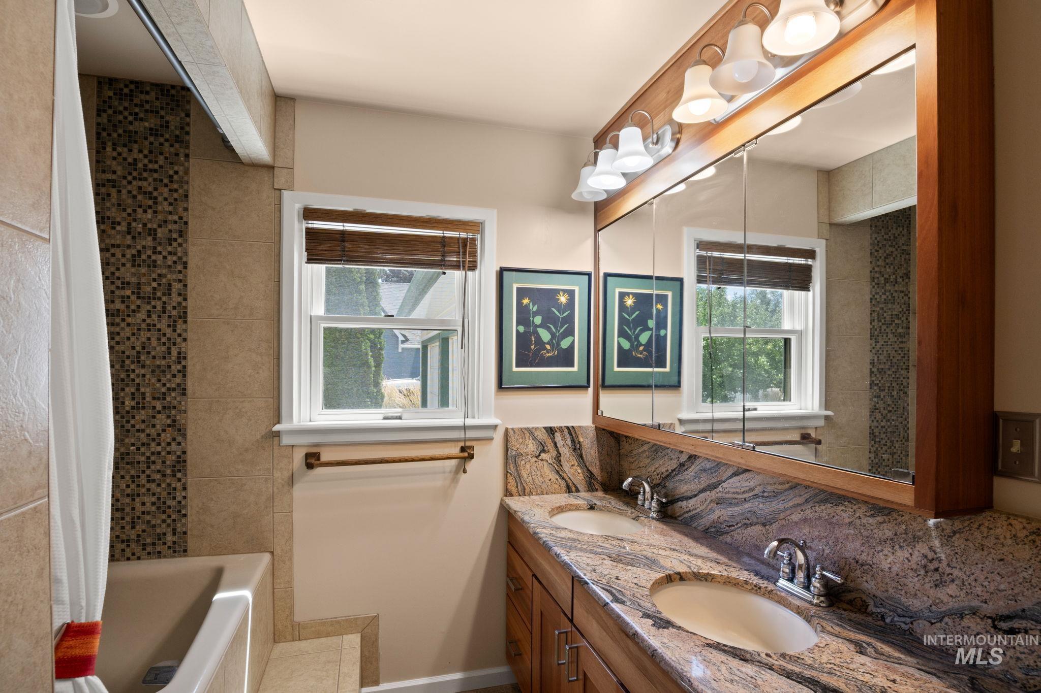 Full bath featuring a sink and shower / bath combo with shower curtain