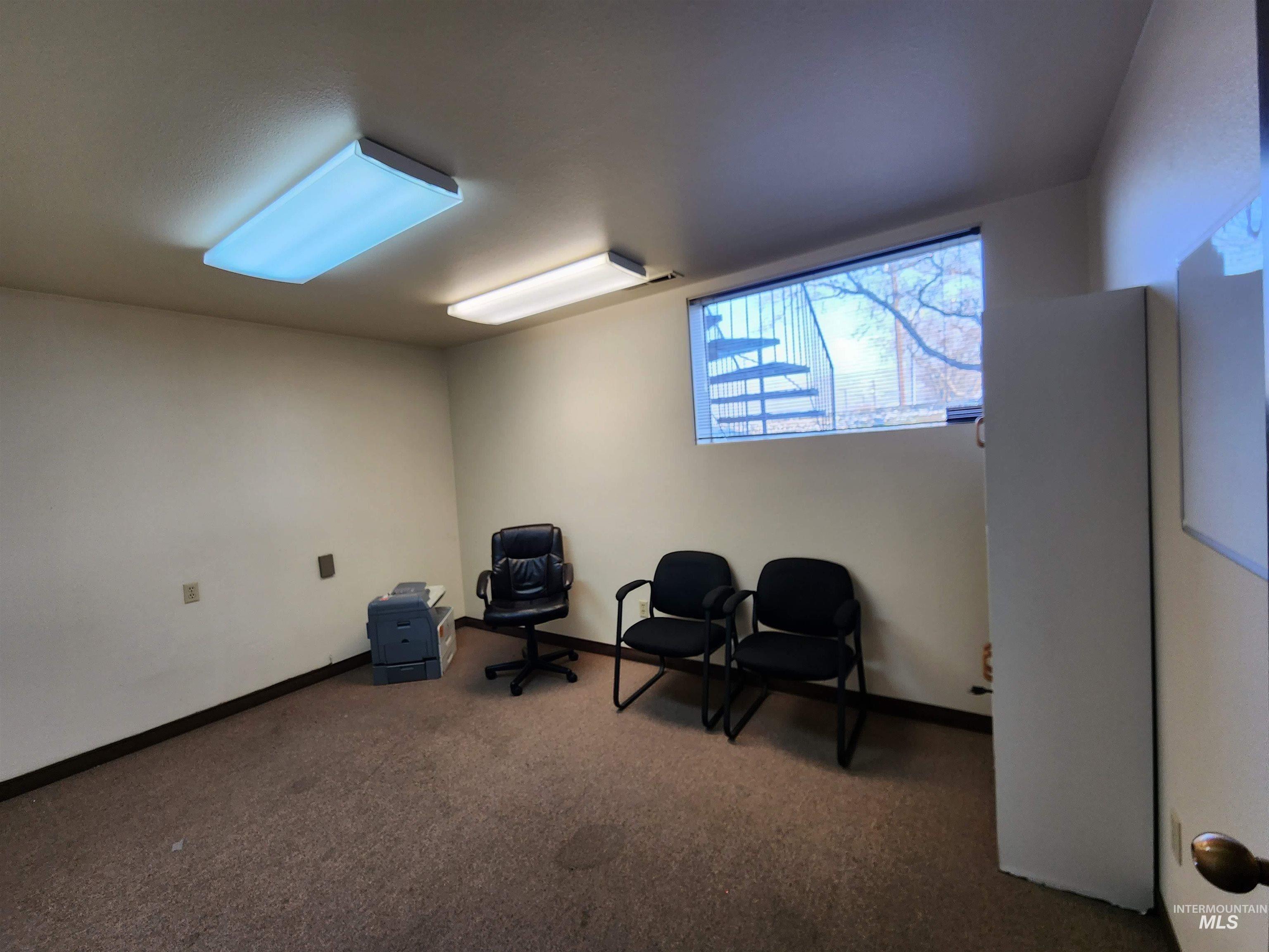 Office with carpet flooring and baseboards