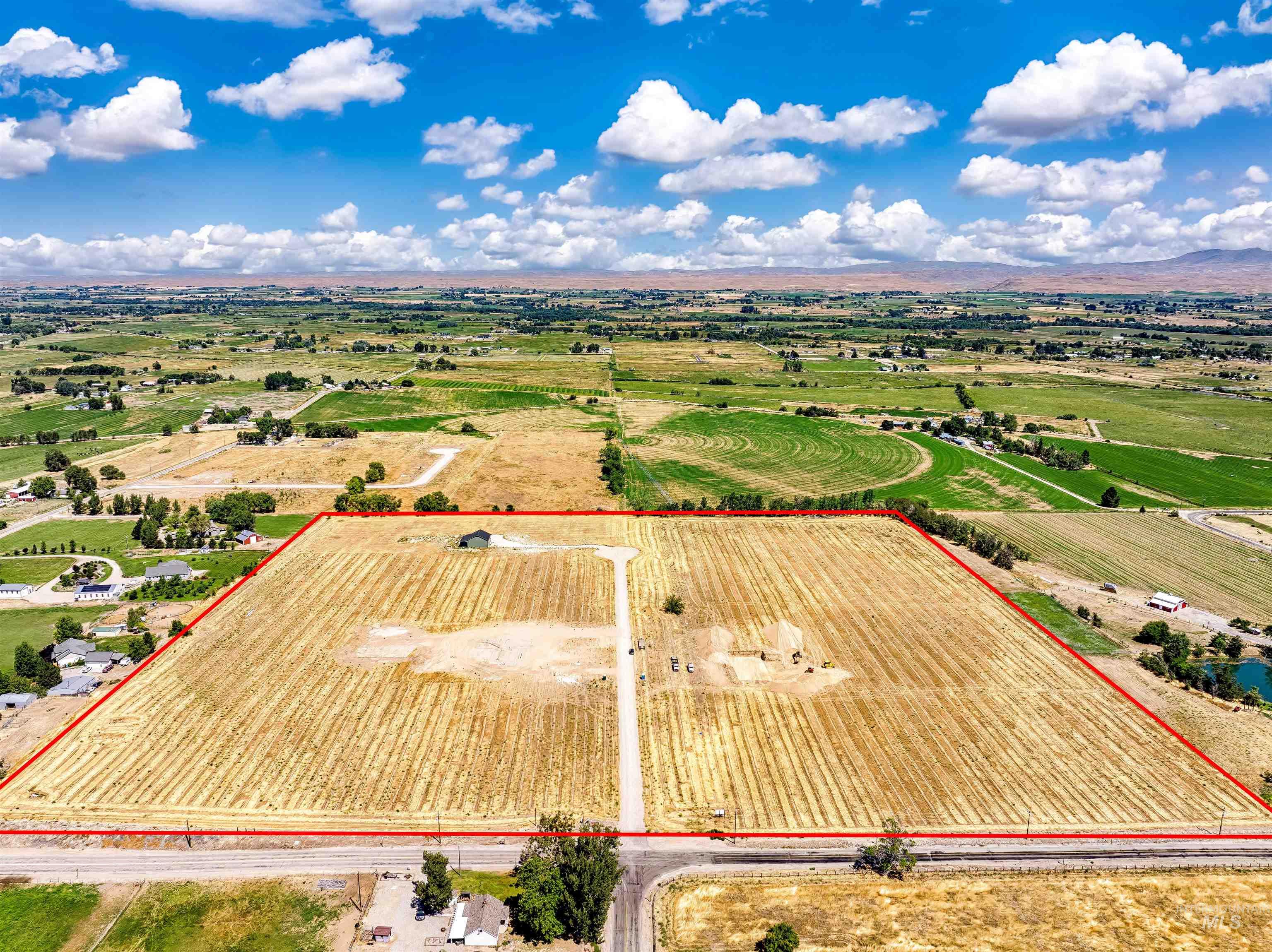 Aerial view of sparsely populated area with property boundaries highlighted and farmland