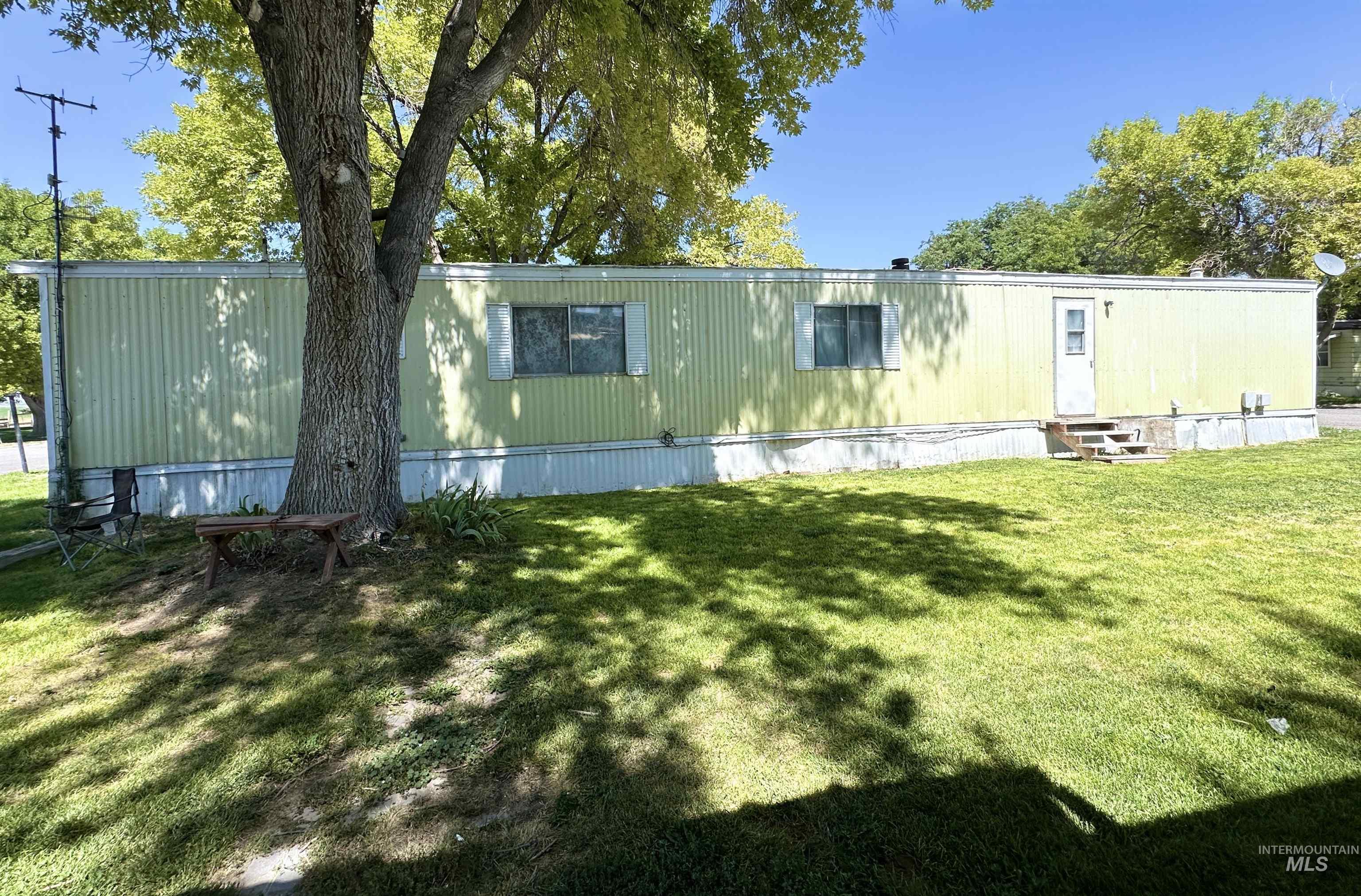 Back of house featuring a yard and entry steps