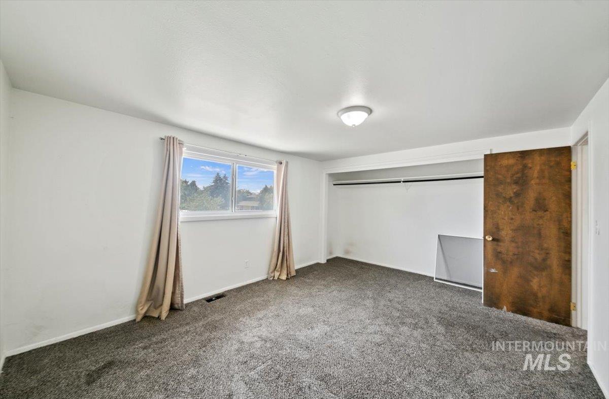 Unfurnished bedroom featuring carpet floors and a closet