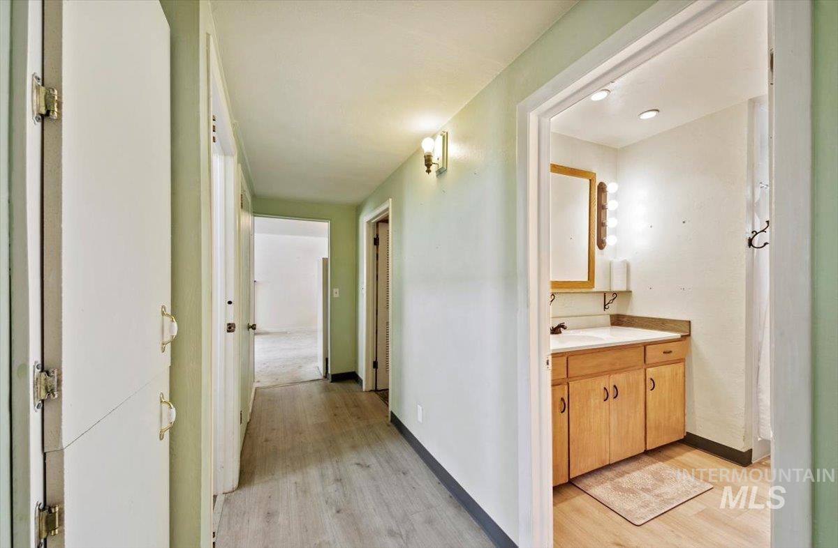 Hallway with light wood-style flooring