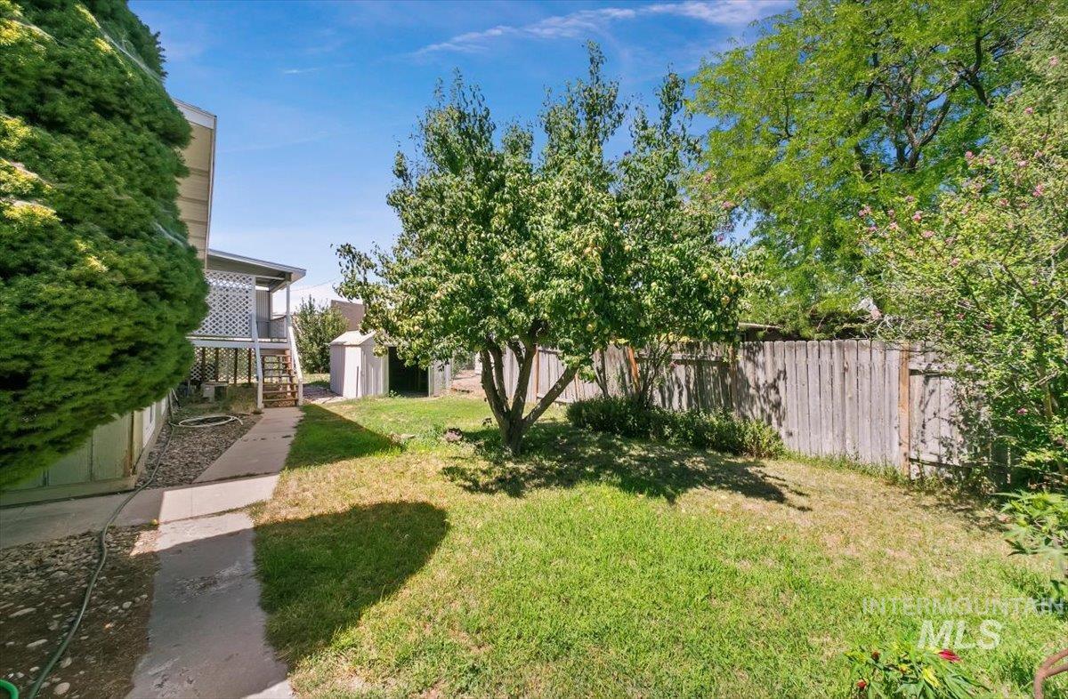 View of yard featuring a storage unit