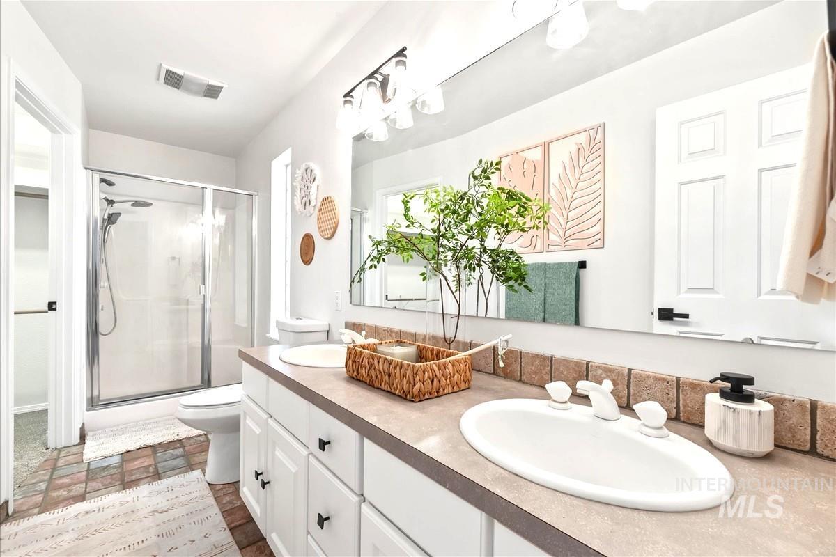 Bathroom with a shower stall and a sink