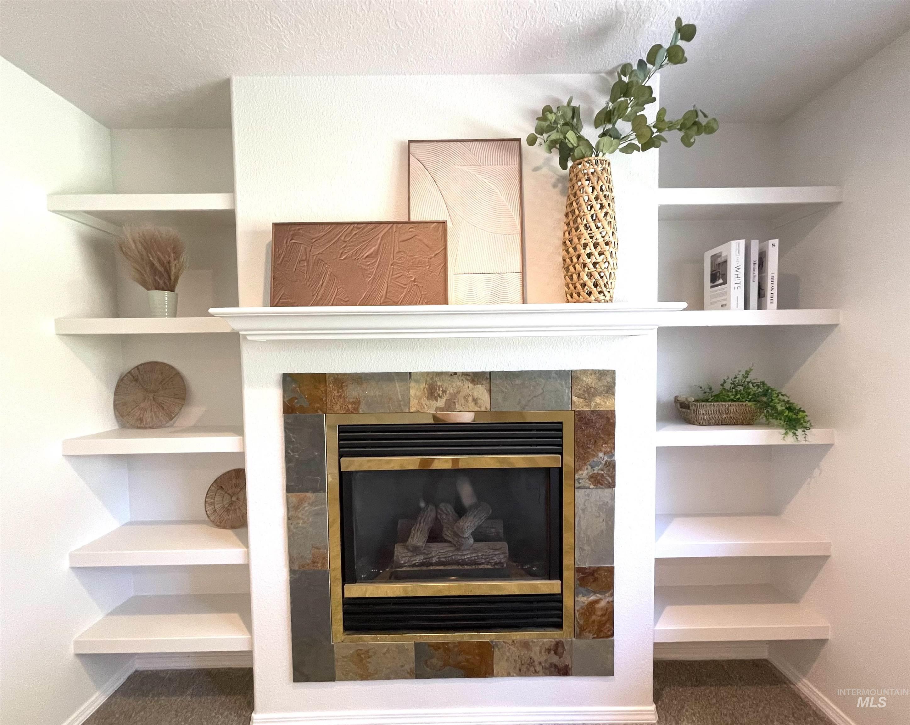 Detailed view of a tiled fireplace and a textured ceiling