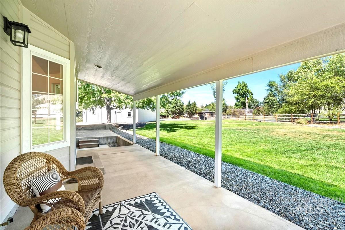 Fenced backyard featuring a patio and an outdoor structure
