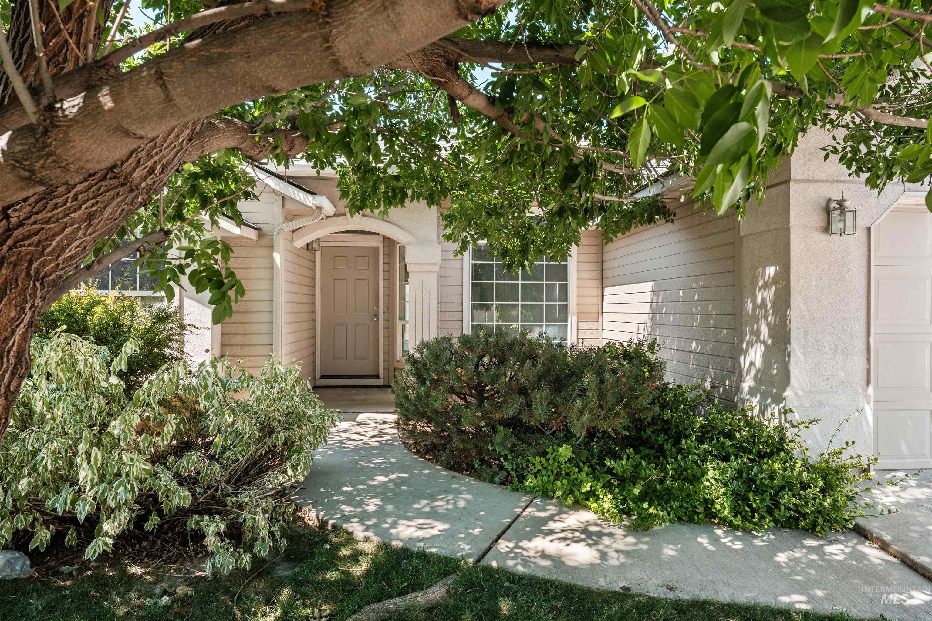 Doorway to property with a garage