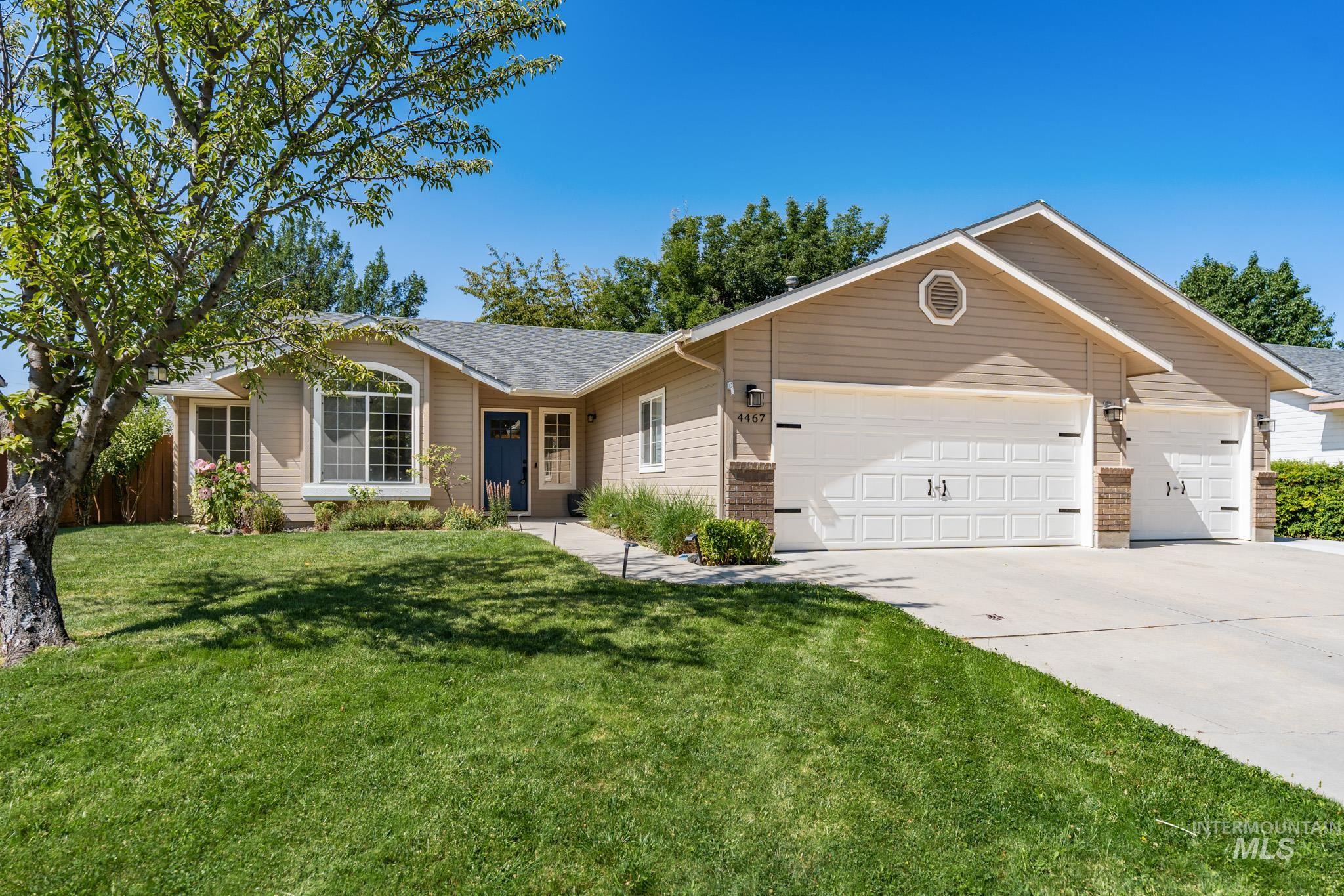 Ranch-style home with a garage, driveway, and roof with shingles