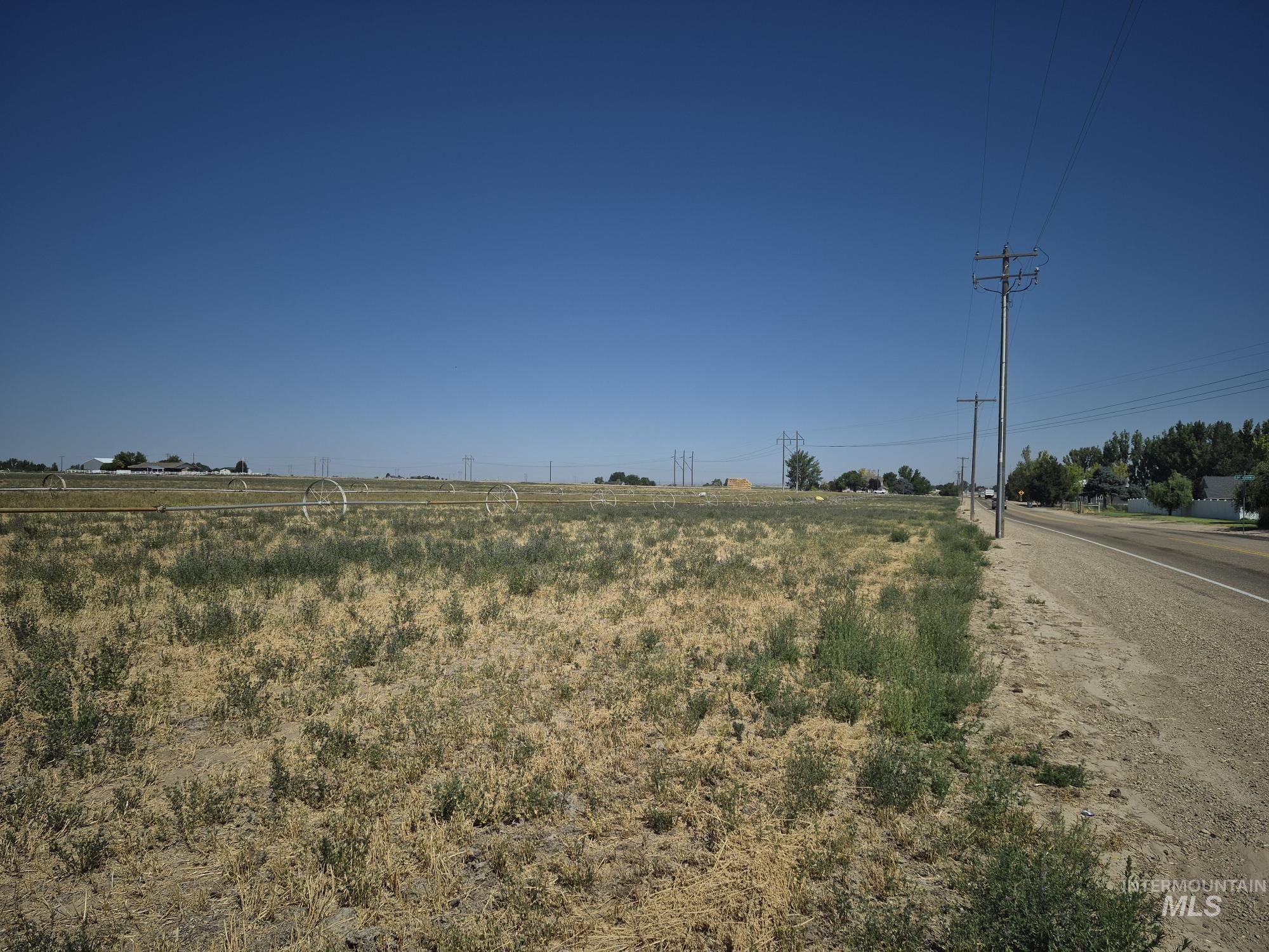 View of asphalt road with a rural view