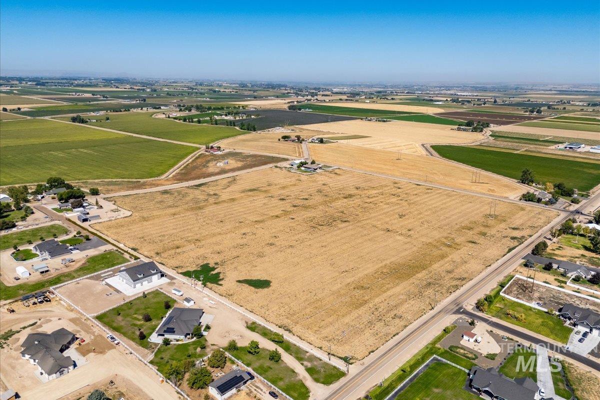 Aerial view of property's location with rural landscape and rows of crops