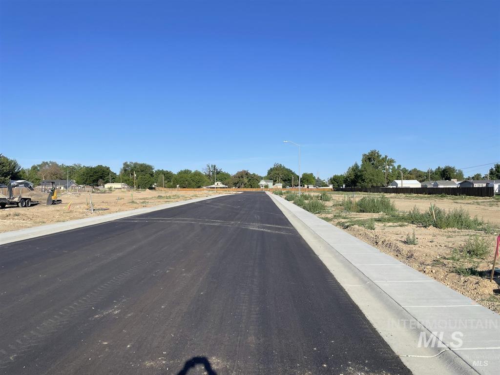 View of asphalt street with curbs and street lighting
